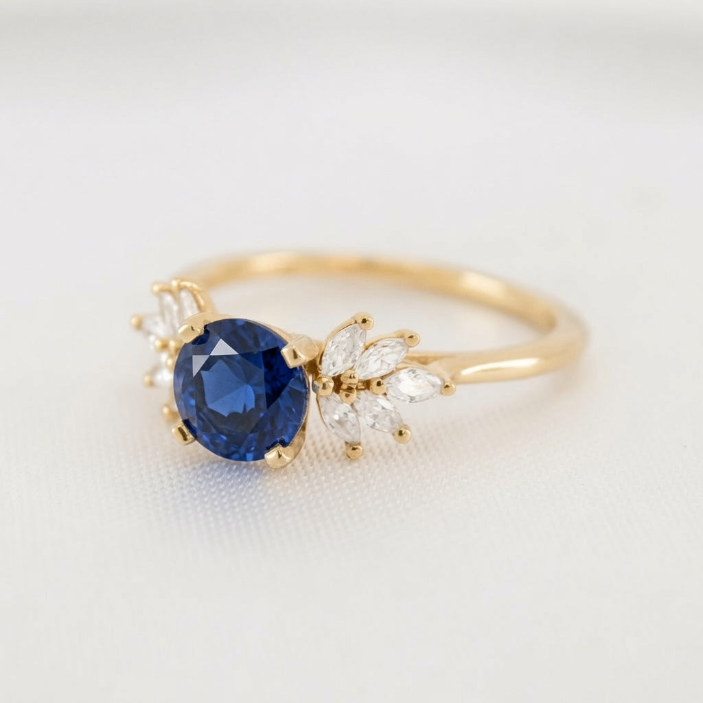 Shown in 2 Carat Sapphire*The Anna sapphire and cluster diamond Engagement Ring with round cut in yellow gold from front angle by Lisa Robin#color_14k_yellow_gold