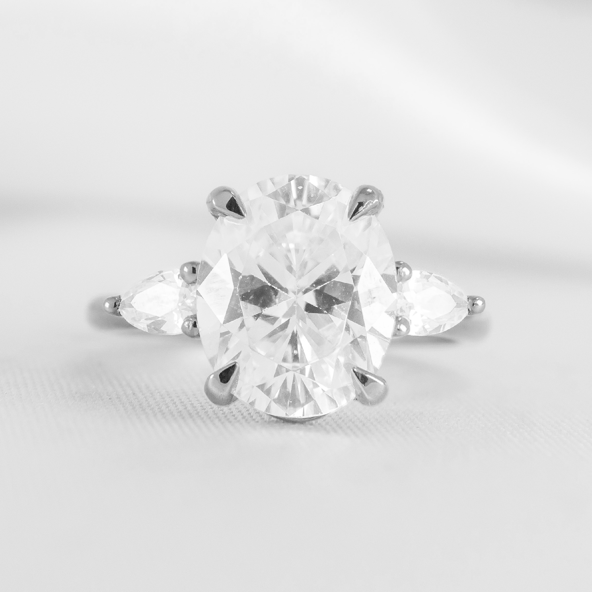 Shown in 2.6 Carat Diamond*The Melayna three stone Engagement Ring with oval cut diamond in platinum from the front by Lisa Robin#color_platinum