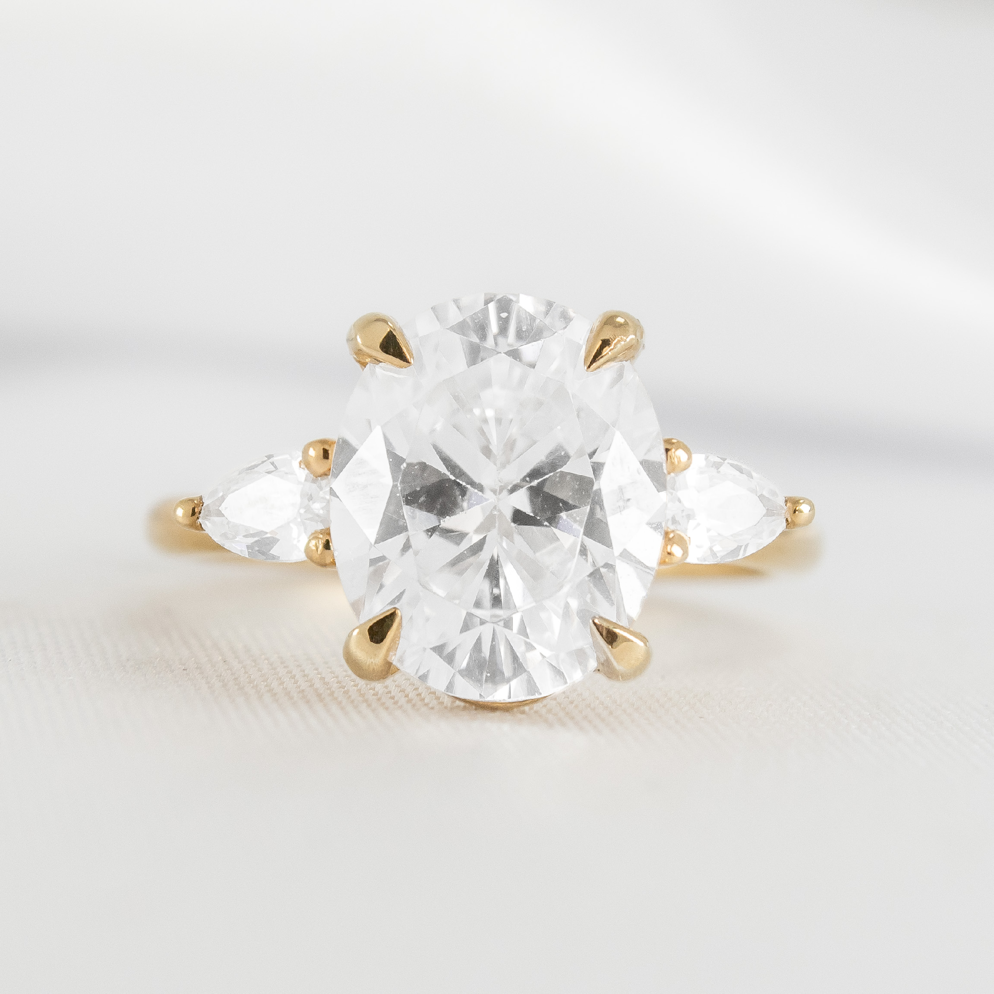 Shown in 2.6 Carat Diamond*The Melayna three stone Engagement Ring with oval cut diamond in yellow gold from the front by Lisa Robin#color_14k-yellow-gold
