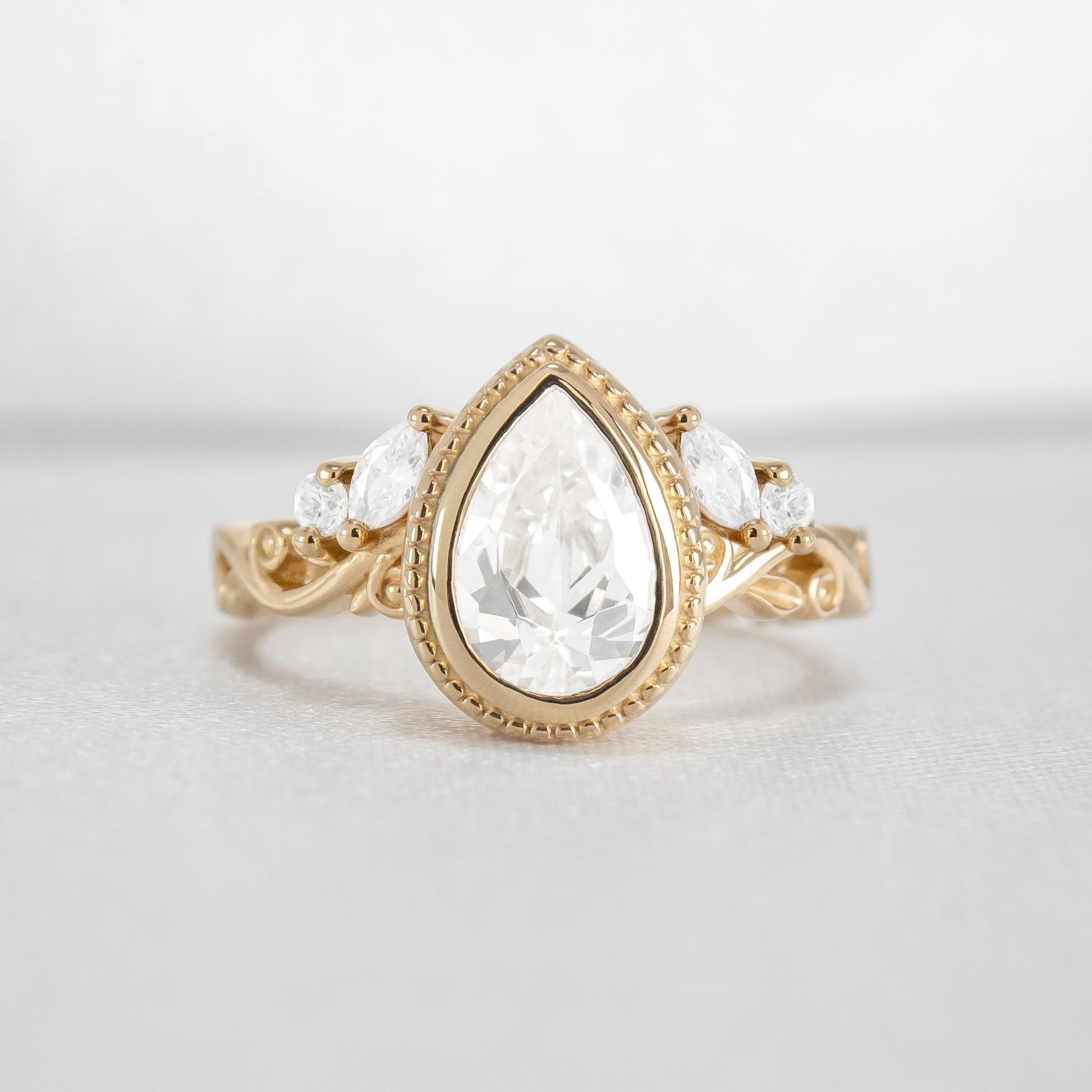 Shown in 2 Carat Diamond*The Fable Symmetry victorian style bezel Engagement Ring with pear cut diamond in yellow gold from front by Lisa Robin#color_14k-yellow-gold