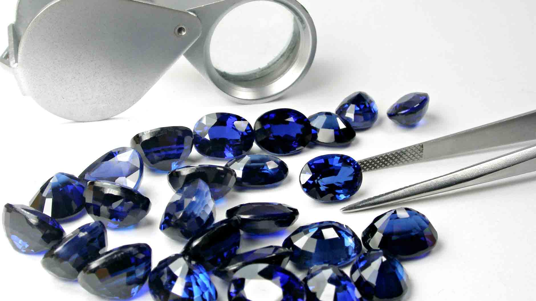 sapphire loose with tweezers and jewelers loupe | Lisa Robin