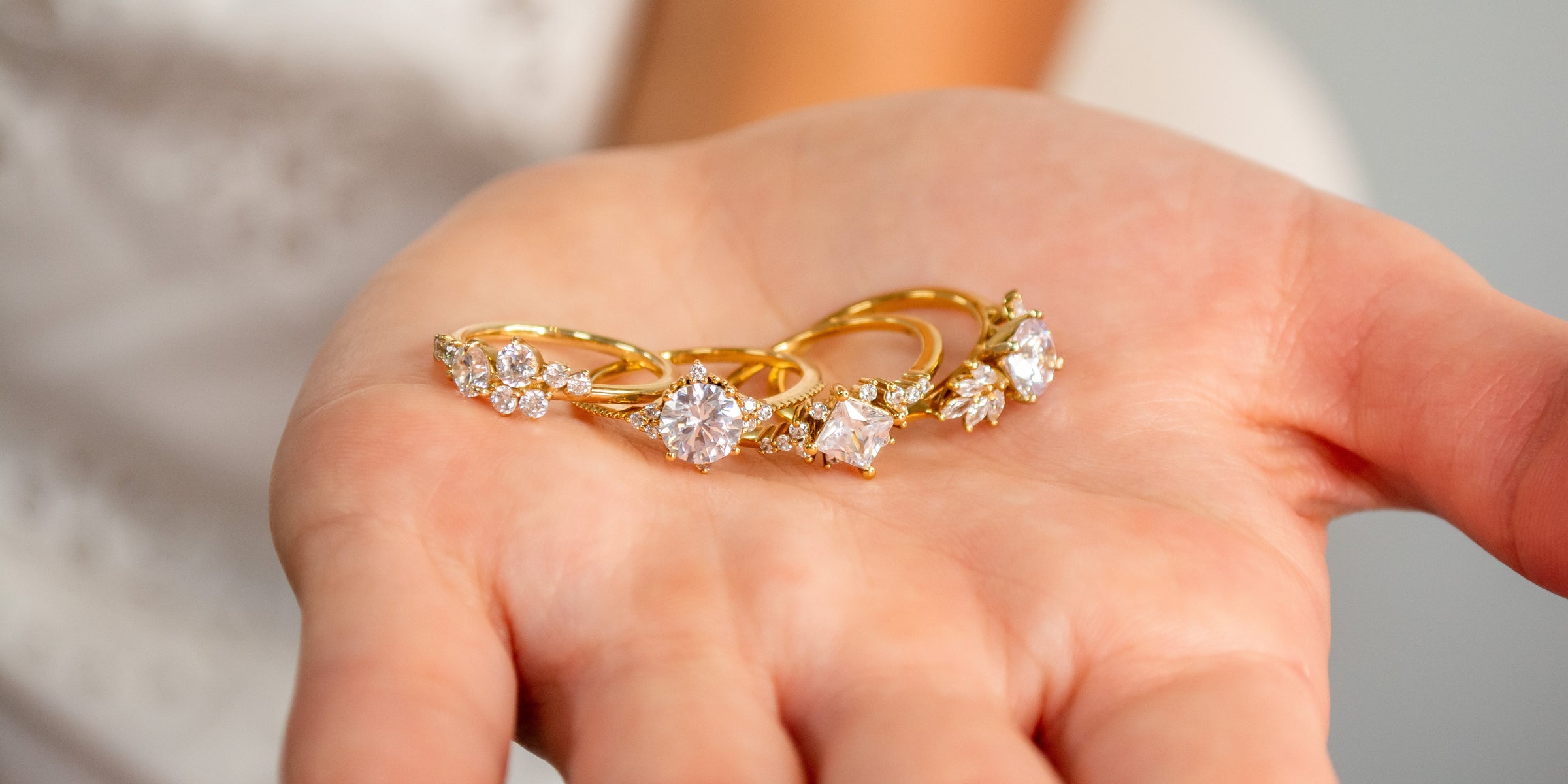 Cluster engagement rings held by model | Lisa Robin