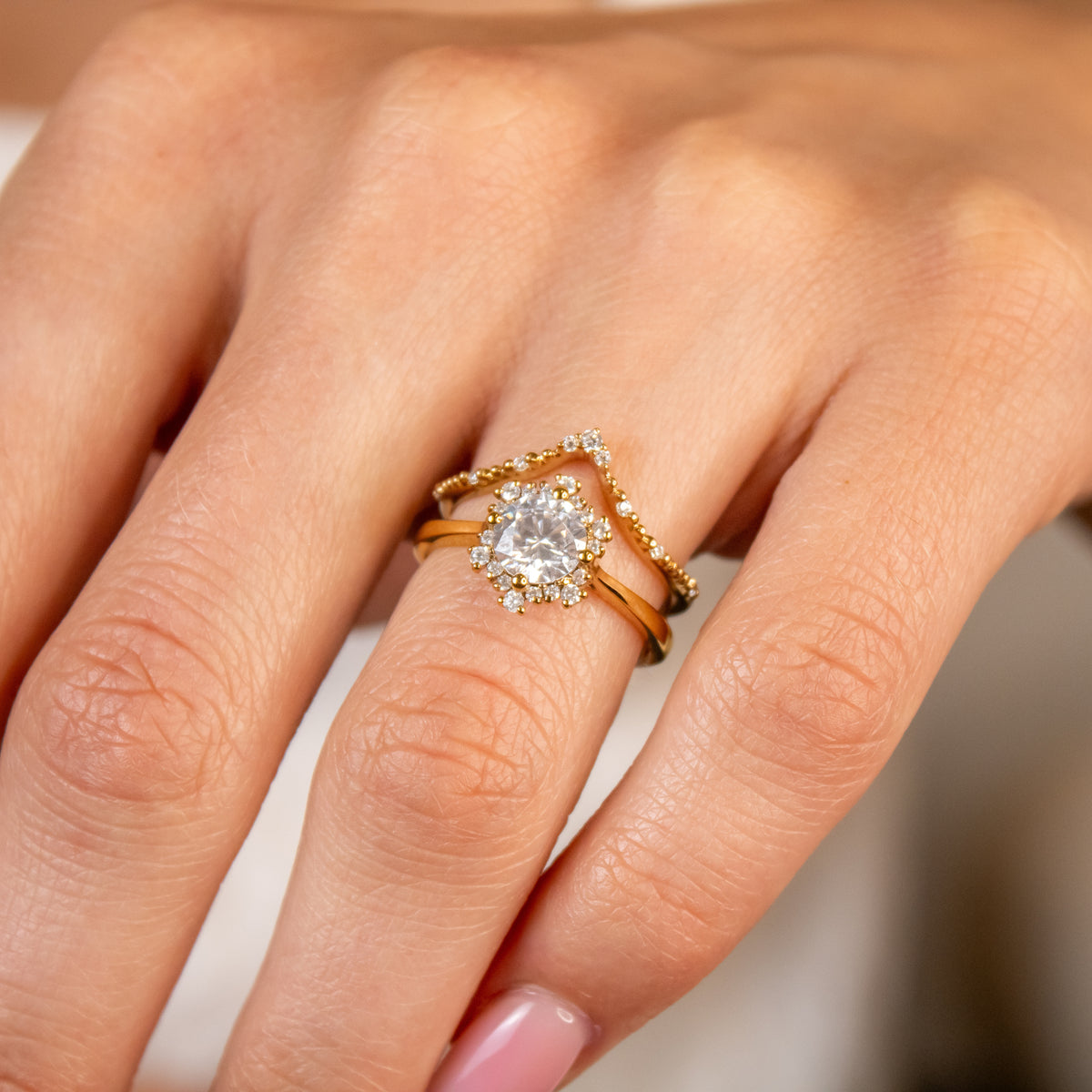 The Aatish Halo Engagement Ring with round cut diamond in yellow gold on model hand by Lisa Robin Jewelry