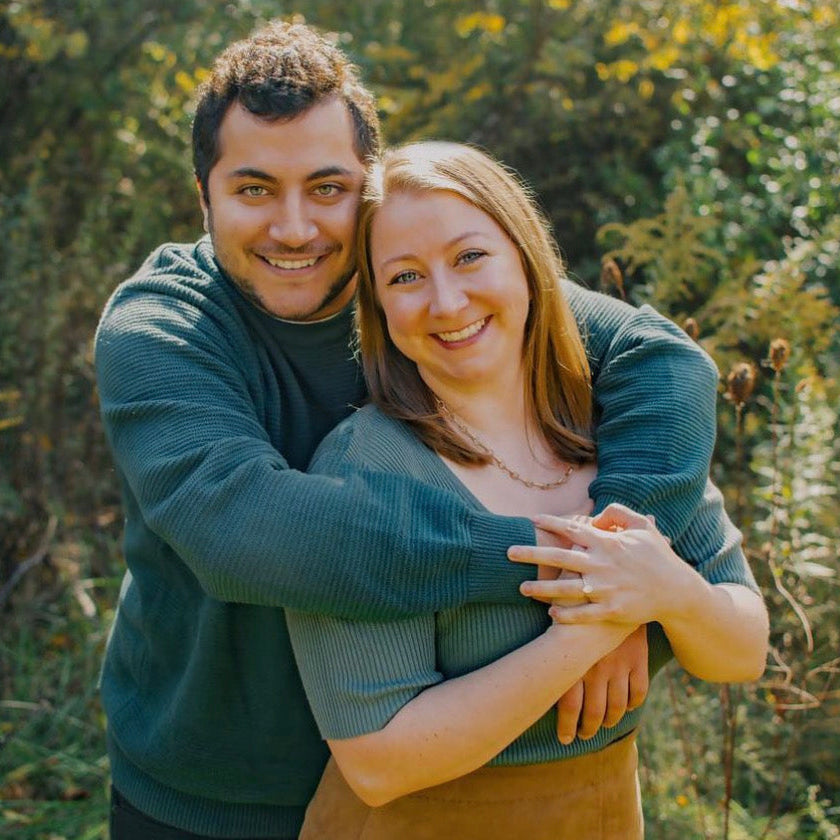Newly engaged couple showing a simple solitaire engagement ring by lisa Robin