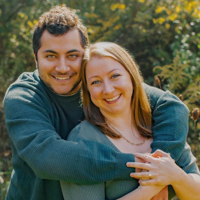 Newly engaged couple showing oval engagement ring by Lisa Robin