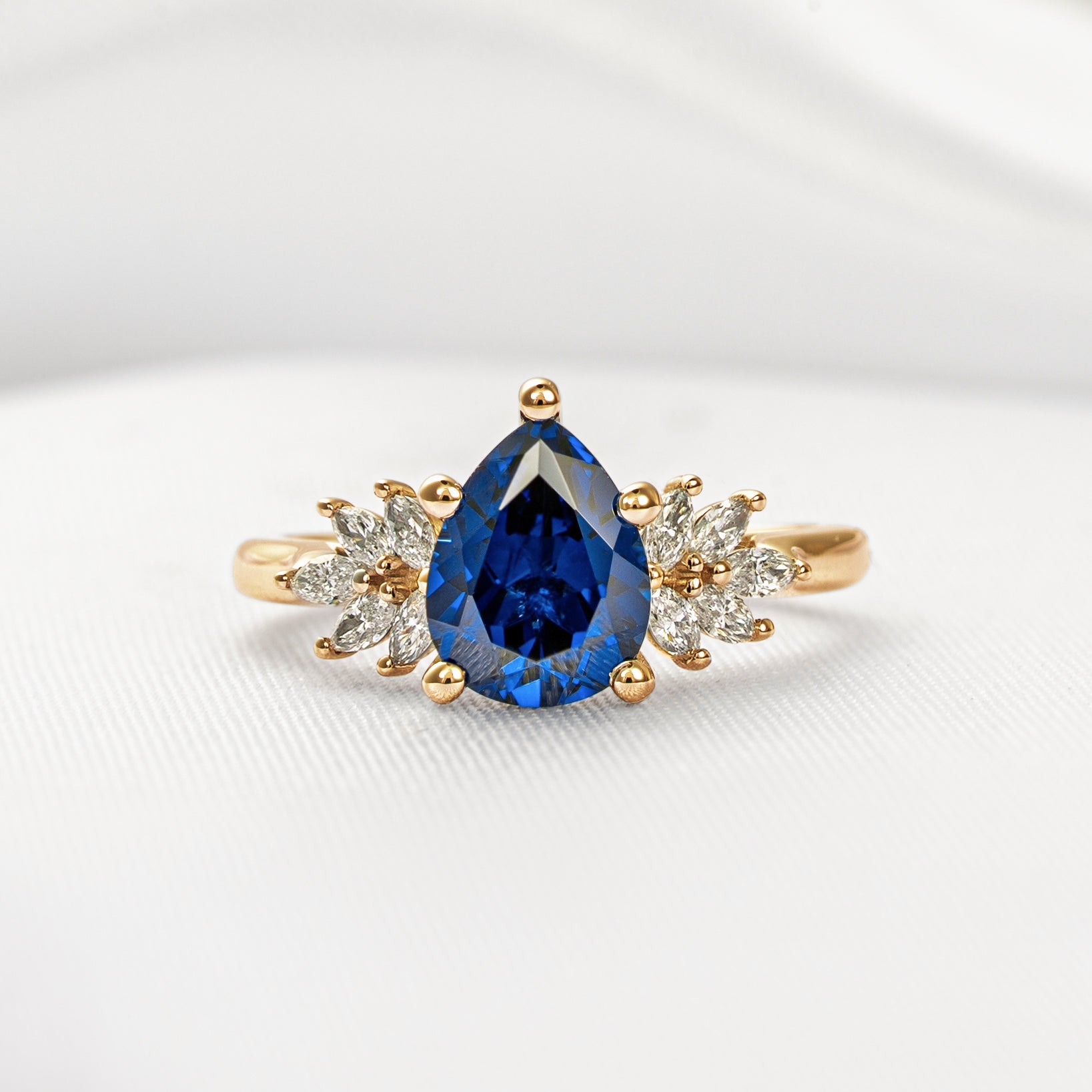 Shown in 2.25 Carat Blue Sapphire*The Anna sapphire and cluster diamond Engagement Ring with pear cut in yellow gold from front by Lisa Robin#color_14k-yellow-gold