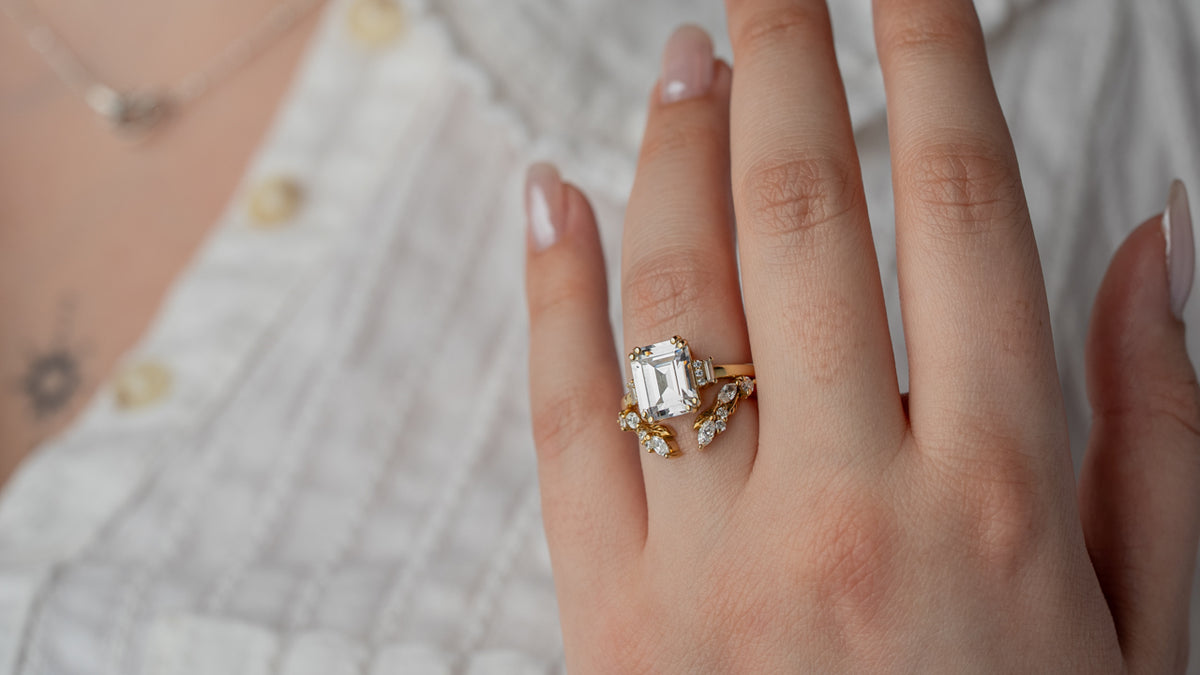 Aston art deco emerald cut engagement ring in yellow gold with Marlowe leaf and vine wedding ring by Lisa Robin