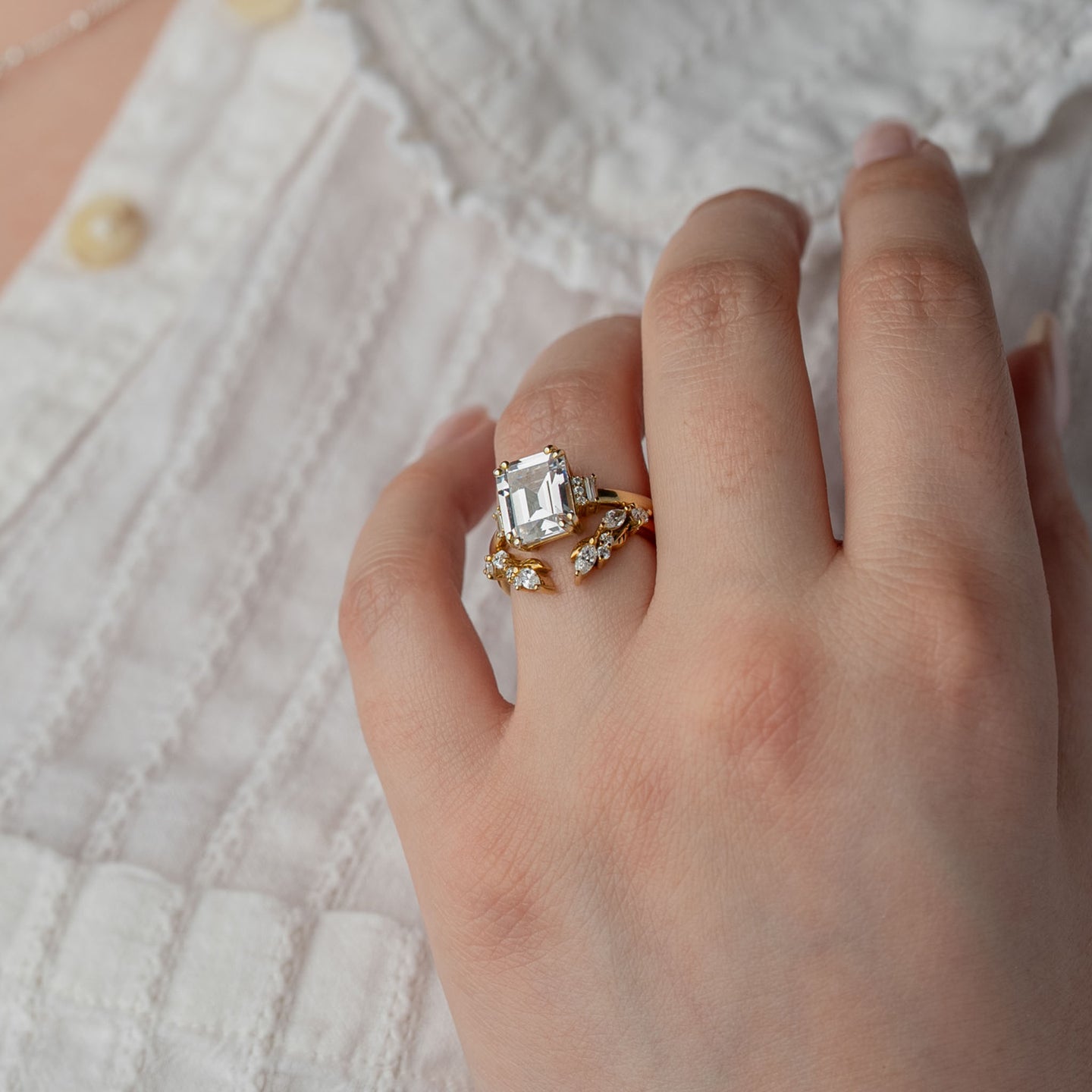 The Aston emerald diamond vintage style engagement ring with round and baguette side stones styled with the Marlow leaf curved open diamond wedding band by Lisa Robin Jewelry