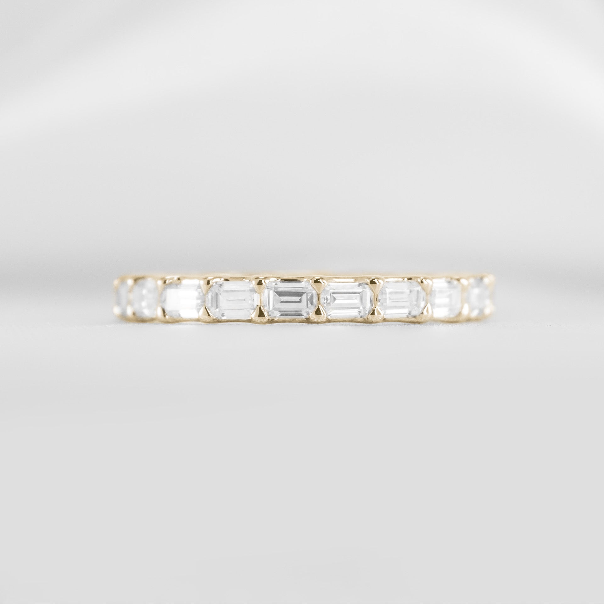 Avery east west emerald cut lab grown eternity 14K yellow gold wedding band by Lisa Robin#color_14k-yellow-gold