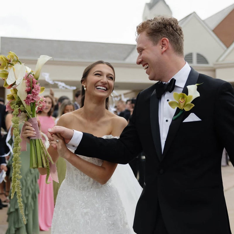 Wedding couple smiling at each other with a church in the background in Dayton, Ohio