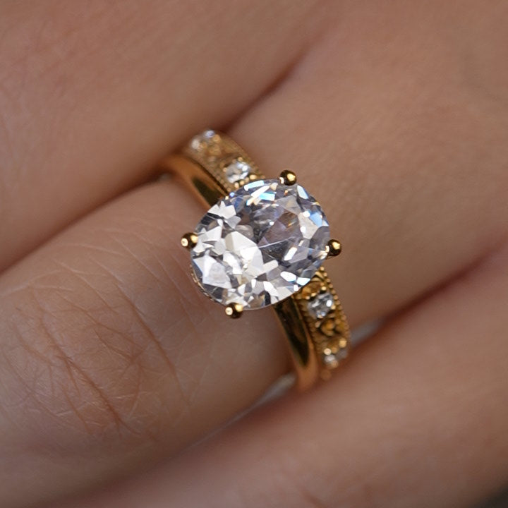 Shown in 2 Carat Diamond*The Casey Hidden Halo Emerald Diamond Engagement Ring with oval cut diamond in yellow gold on model hand by Lisa Robin#color_14k-yellow-gold#shape_all