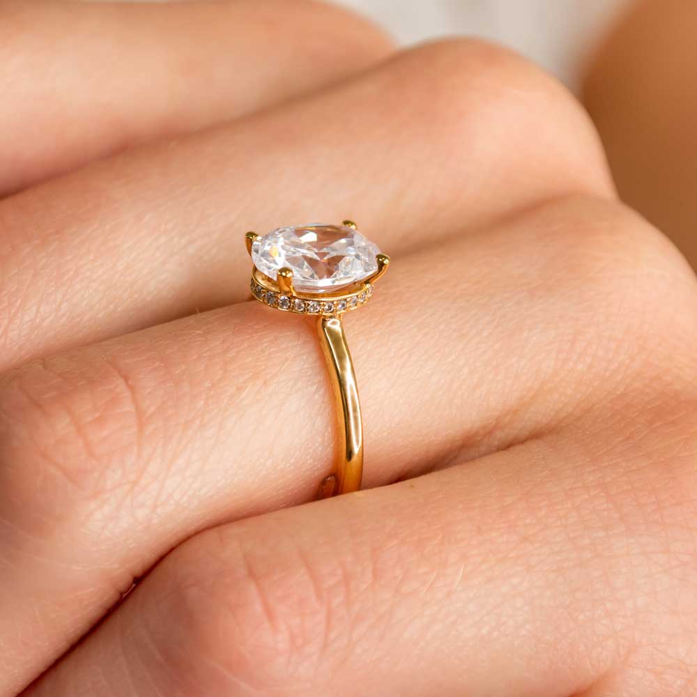 Shown in 1.8 Carat Diamond*The Casey Hidden Halo Emerald Diamond Engagement Ring with oval cut diamond in yellow gold on model hand by Lisa Robin#color_14k-yellow-gold#shape_oval