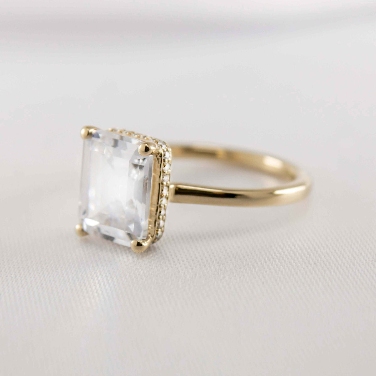 Shown in 2 Carat Diamond*The Casey Hidden Halo Emerald Diamond Engagement Ring with emerald cut diamond in yellow gold from front angle view by Lisa Robin#color_14k-yellow-gold#shape_emerald
