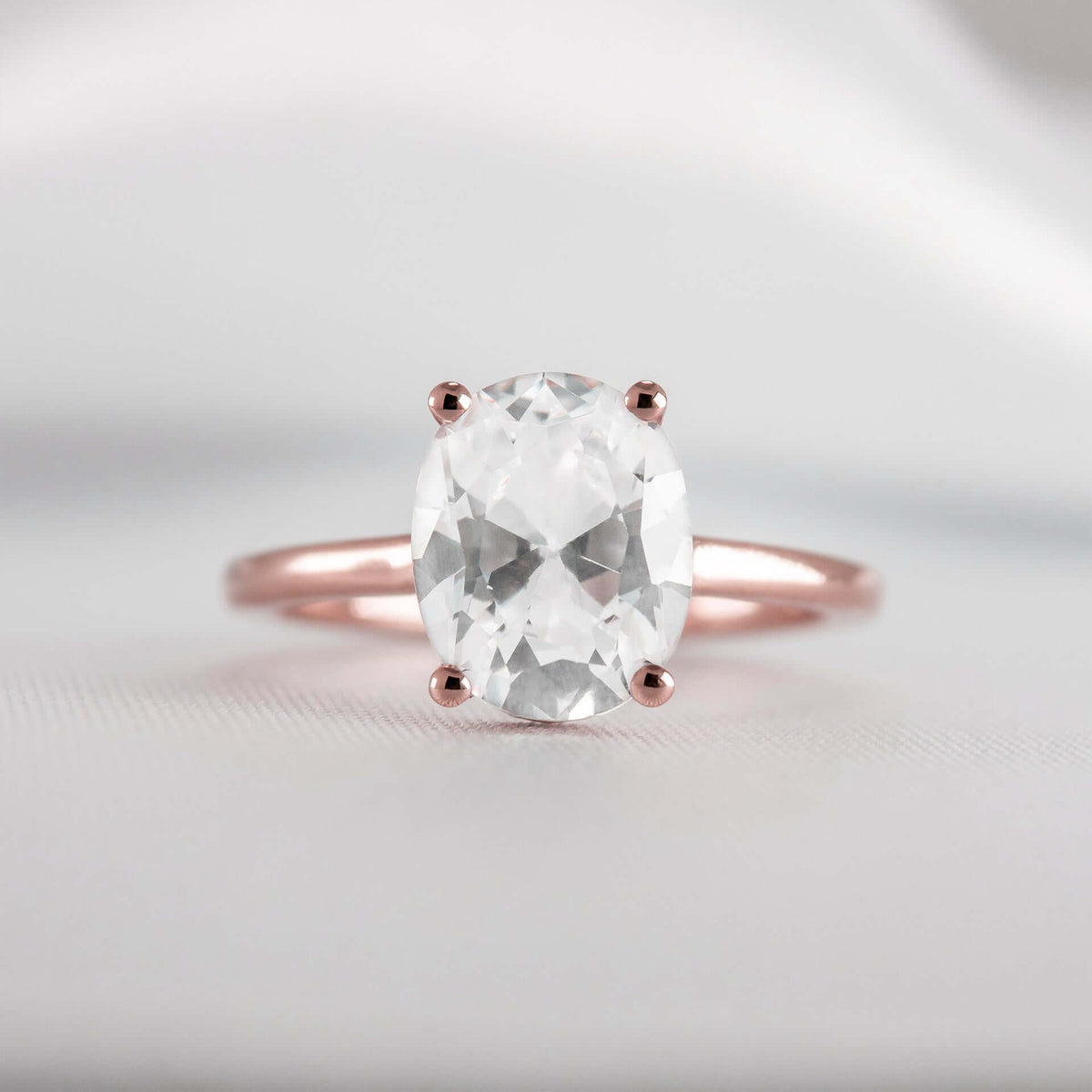 Shown in 1.8 Carat Diamond*The Casey Hidden Halo Emerald Diamond Engagement Ring with oval cut diamond in rose gold from front by Lisa Robin#color_14k-rose-gold#shape_oval