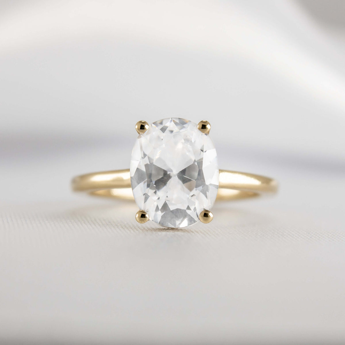 Shown in 1.8 Carat Diamond*The Casey Hidden Halo Emerald Diamond Engagement Ring with oval cut diamond in yellow gold from front by Lisa Robin#color_14k-yellow-gold#shape_oval