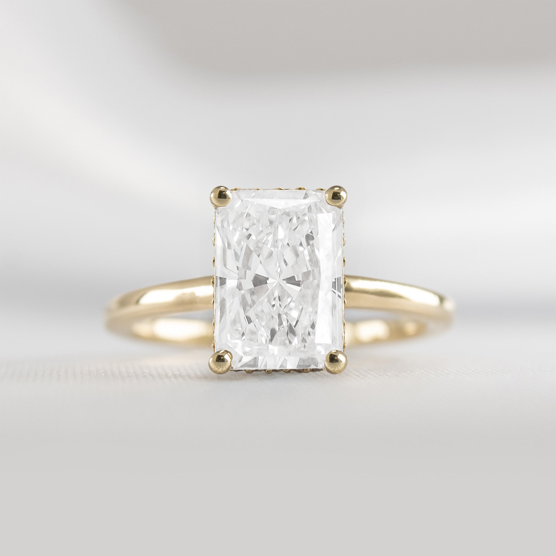 Shown in 2 Carat Diamond*The Casey Hidden Halo Emerald Diamond Engagement Ring with radiant cut diamond in yellow gold from front by Lisa Robin#color_14k-yellow-gold#shape_radiant