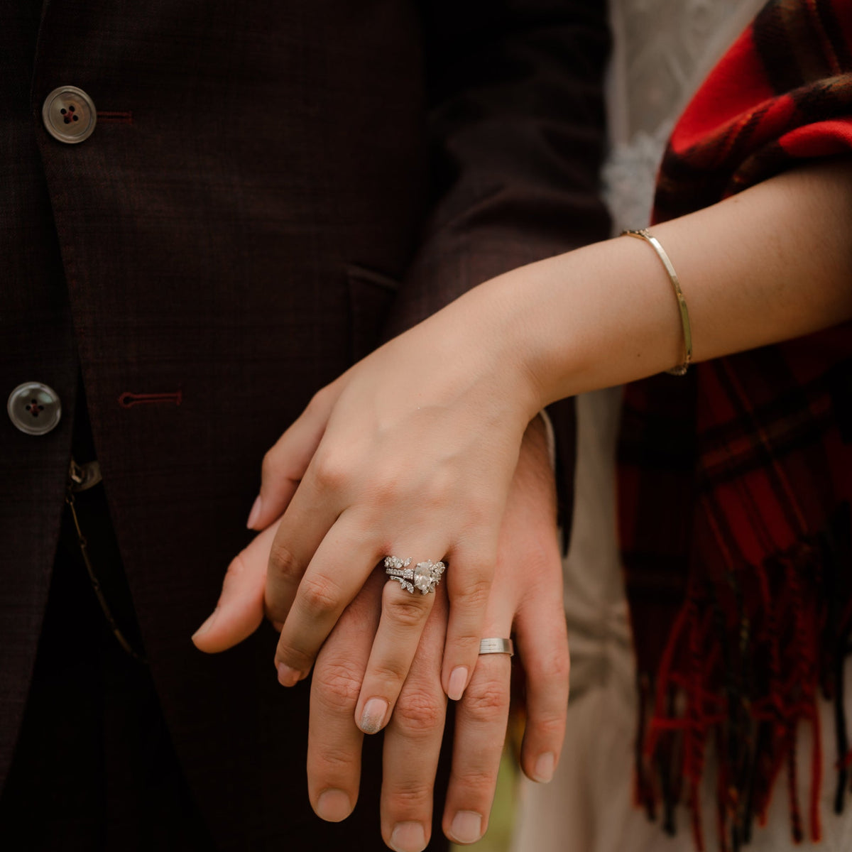 Newlyweds showing his and hers wedding rings on clasped hands | Lisa Robin