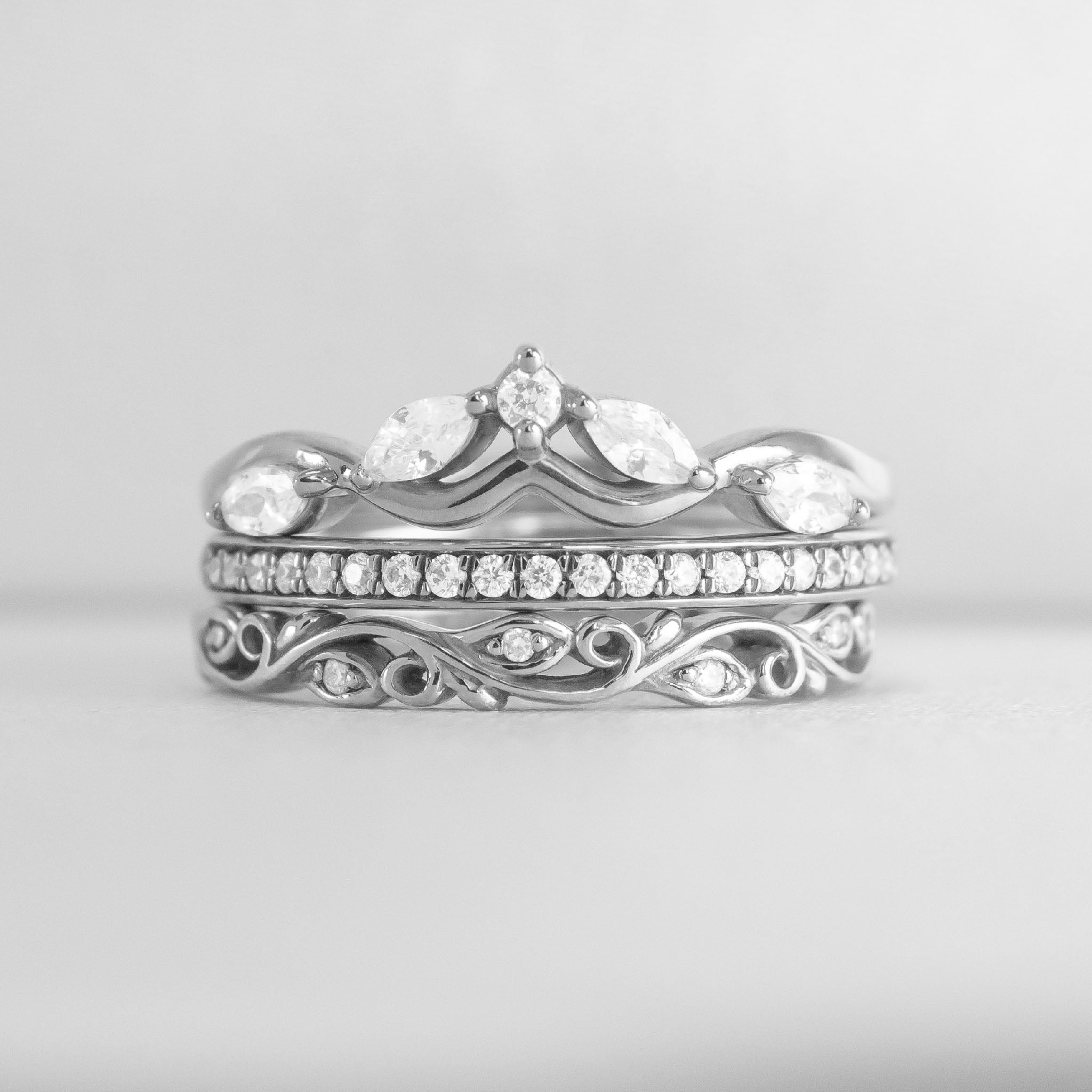 The Ensemble Ring Stack Set comprised of the Evara twist diamond 14K white gold wedding ring with Macey Pave Diamond Wedding Ring in 14K white gold and Leaf and Vine Diamond Wedding Ring in 14K white gold from front by Lisa Robin#color_14k-white-gold