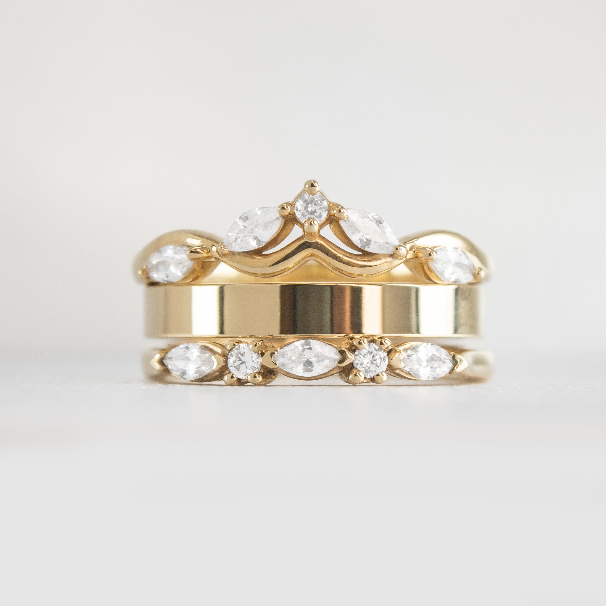 The Ensemble Ring Stack Set comprised of the Evara twist diamond 14K yellow gold wedding ring with Jamie 2.5mm Wide Flat Wedding Ring in 14K yellow gold and Blake Marquise Cut Diamond Wedding Ring in 14K yellow gold from front by Lisa Robin#color_14k-yellow-gold