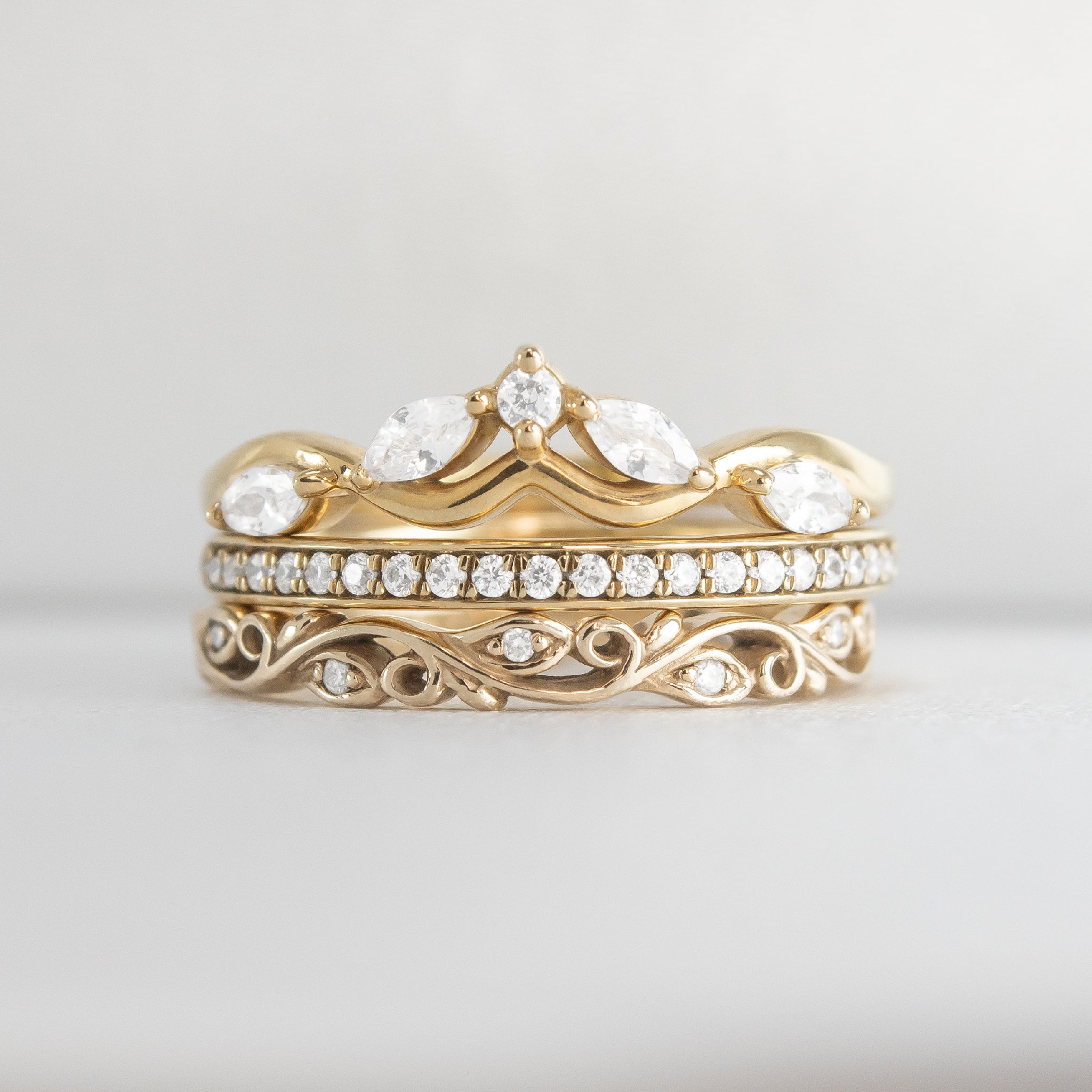 The Ensemble Ring Stack Set comprised of the Evara twist diamond 14K yellow gold wedding ring with Macey Pave Diamond Wedding Ring in 14K yellow gold and Leaf and Vine Diamond Wedding Ring in 14K yellow gold from front by Lisa Robin#color_14k-yellow-gold