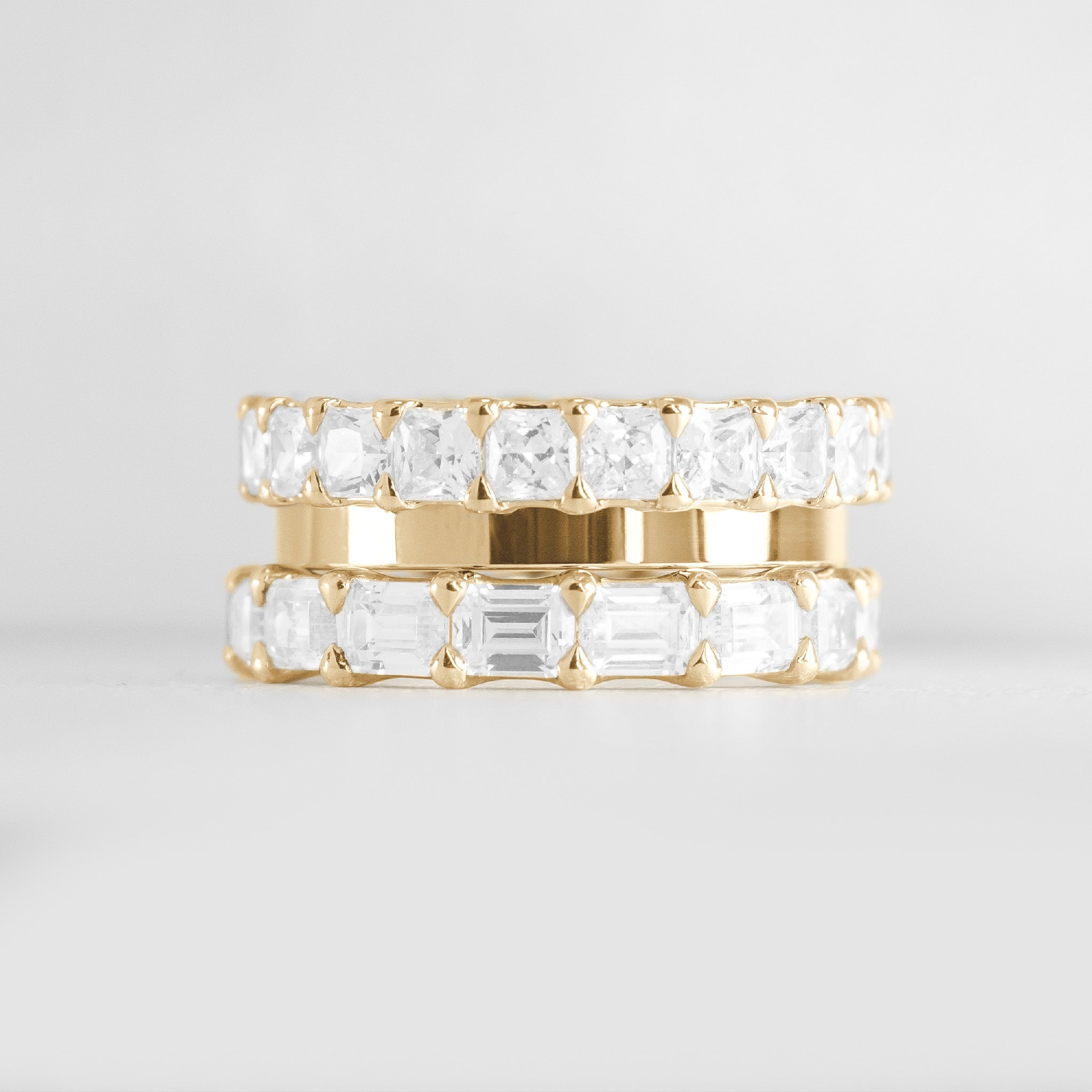 The Ensemble Ring Stack Set comprised of the Lindon Princess Cut diamond Eternity Wedding Band in 14K yellow gold with Jamie 2mm Wide Flat Wedding Ring in 14K yellow gold and Aniston Emerald Cut Diamond Eternity Wedding Ring in 14K yellow gold from front by Lisa Robin#color_14k-yellow-gold