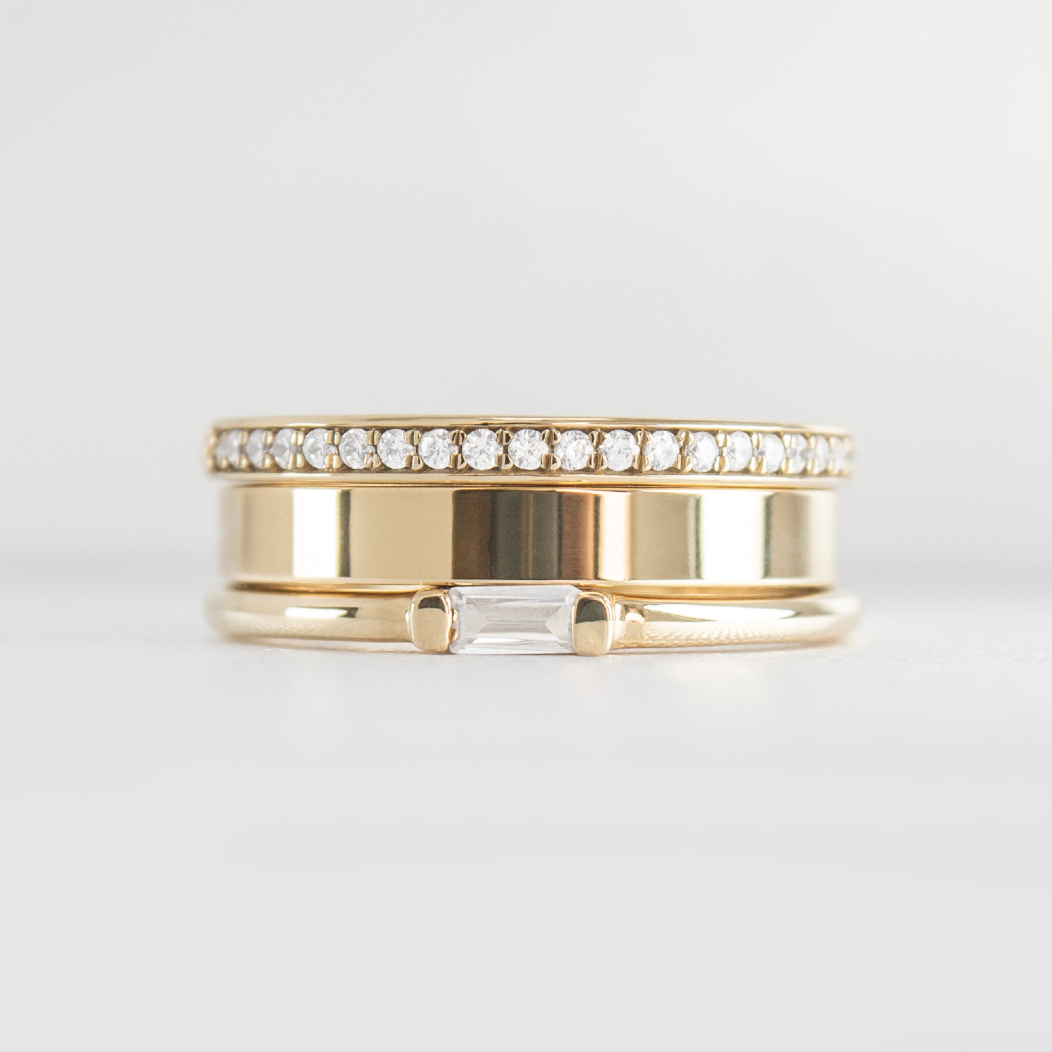 The Ensemble Ring Stack Set comprised of the Macey Pavé Diamond Wedding Ring in 14K yellow gold with Jamie 4mm Wide Flat Wedding Ring in 14K yellow gold and Dominic Baguette Diamond Wedding Ring in 14K yellow gold from front by Lisa Robin#color_14k-yellow-gold