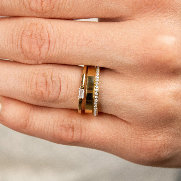 The Ensemble Ring Stack Set comprised of the Macey Pavé Diamond Wedding Ring in 14K yellow gold with Jamie 4mm Wide Flat Wedding Ring in 14K yellow gold and Dominic Baguette Diamond Wedding Ring in 14K yellow gold on model hand by Lisa Robin#color_14k-yellow-gold