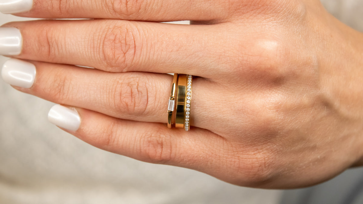 Ensemble stack rings with diamonds and yellow gold on model hand from Lisa Robin