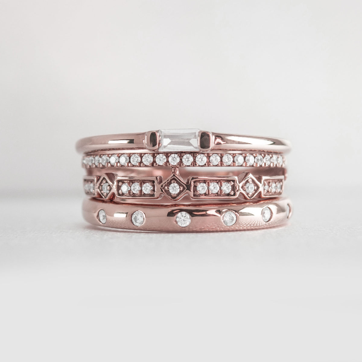 The Ensemble Ring Stack Set comprised of the Dominic Baguette Diamond Wedding Ring in 14K rose gold with Reese Dome Diamond Wedding Ring in 14K rose gold and Rene Diamond Wedding Ring in 14K rose gold from front by Lisa Robin#color_14k-rose-gold