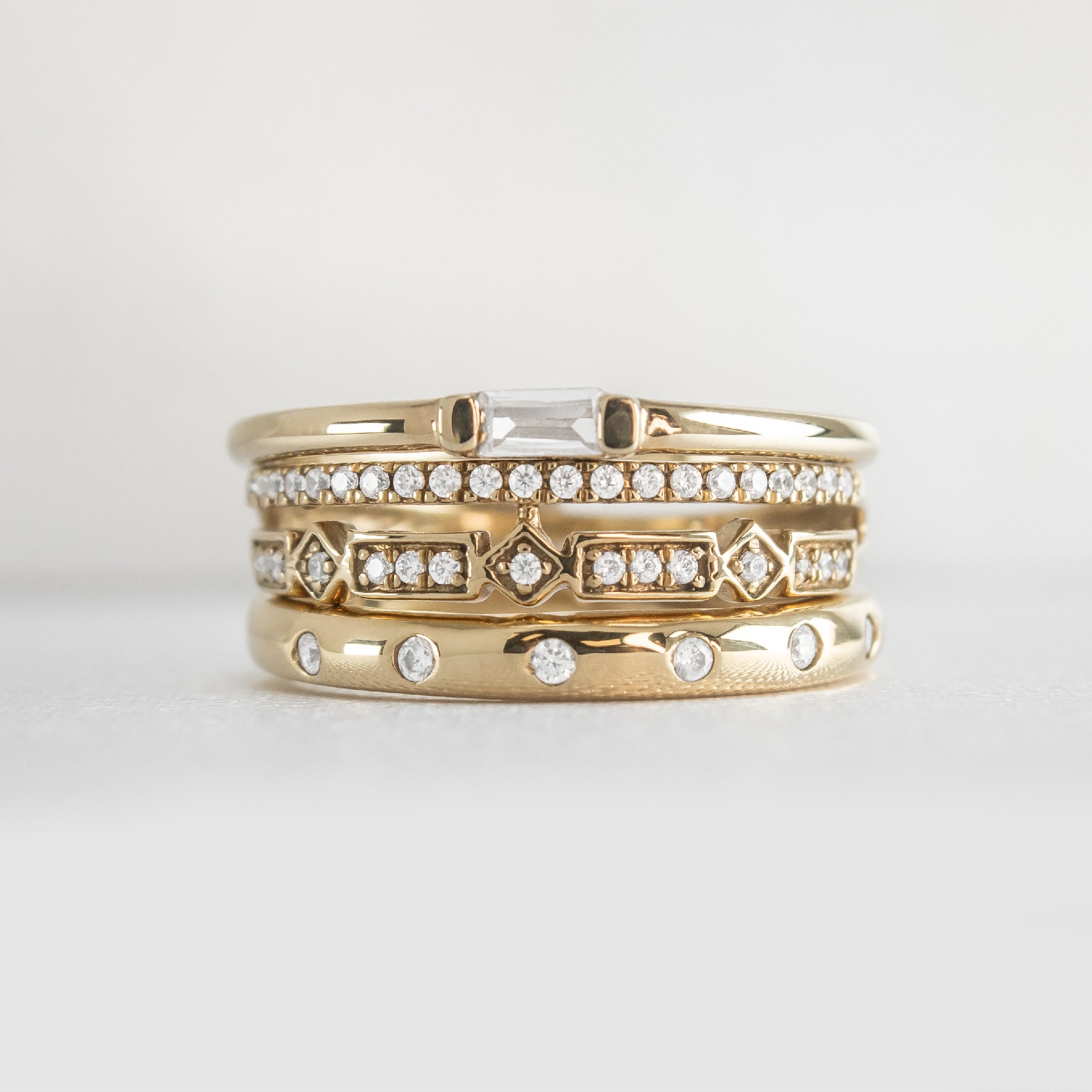 The Ensemble Ring Stack Set comprised of the Dominic Baguette Diamond Wedding Ring in 14K yellow gold with Reese Dome Diamond Wedding Ring in 14K yellow gold and Rene Diamond Wedding Ring in 14K yellow gold from front by Lisa Robin#color_14k-yellow-gold