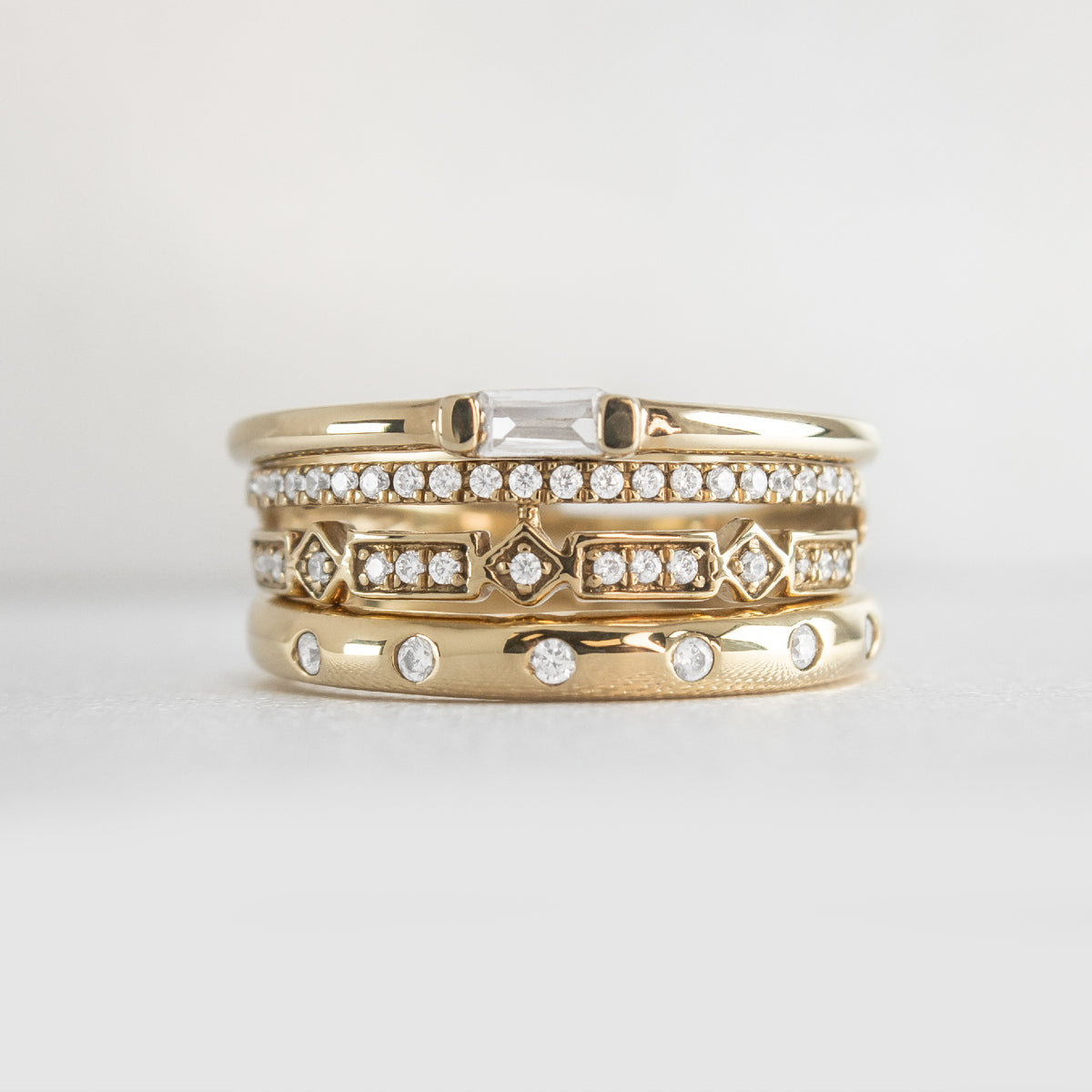 The Ensemble Ring Stack Set comprised of the Dominic Baguette Diamond Wedding Ring in 14K yellow gold with Reese Dome Diamond Wedding Ring in 14K yellow gold and Rene Diamond Wedding Ring in 14K yellow gold from front by Lisa Robin#color_14k-yellow-gold