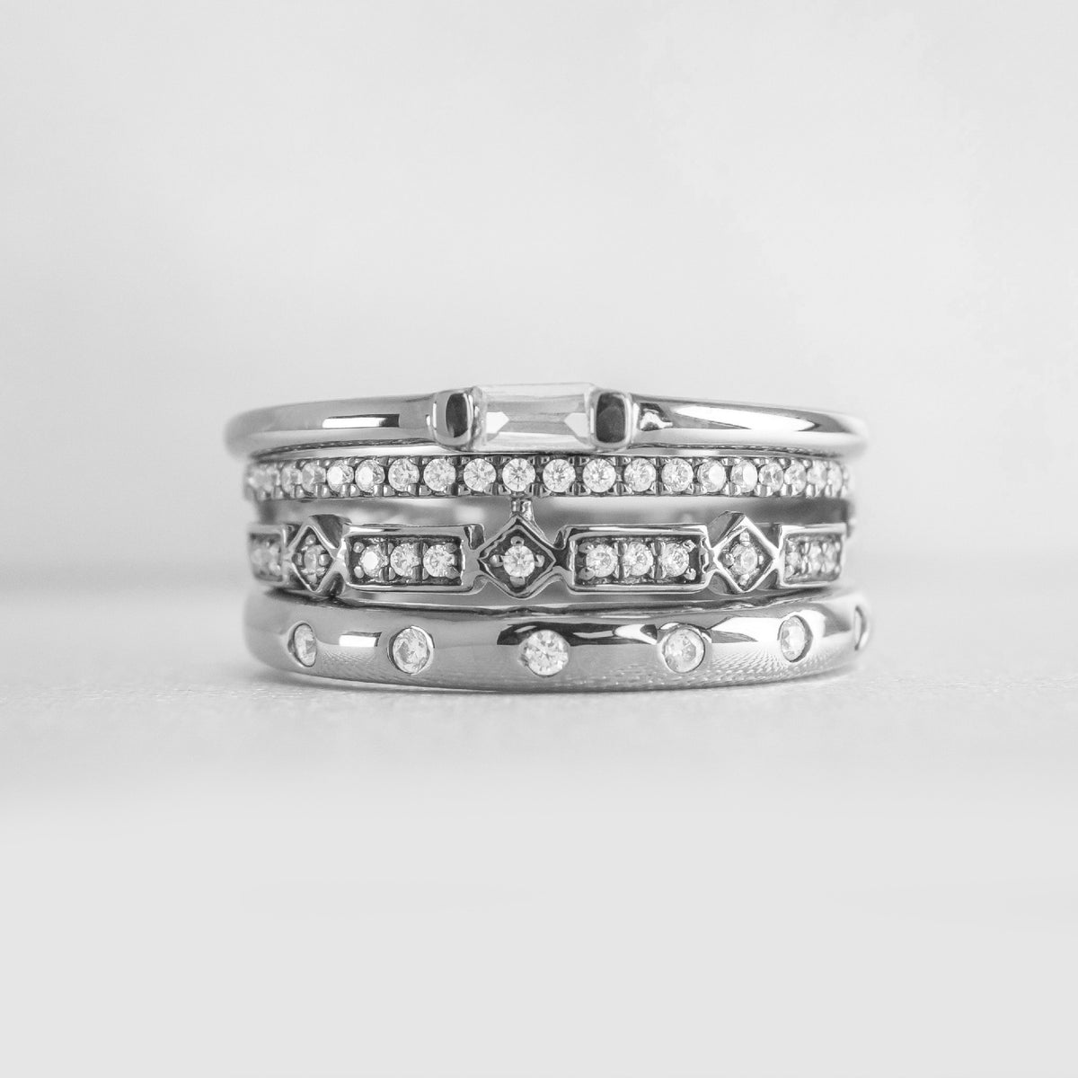 The Ensemble Ring Stack Set comprised of the Dominic Baguette Diamond Wedding Ring in platinum with Reese Dome Diamond Wedding Ring in platinum and Rene Diamond Wedding Ring in platinum from front by Lisa Robin#color_platinum