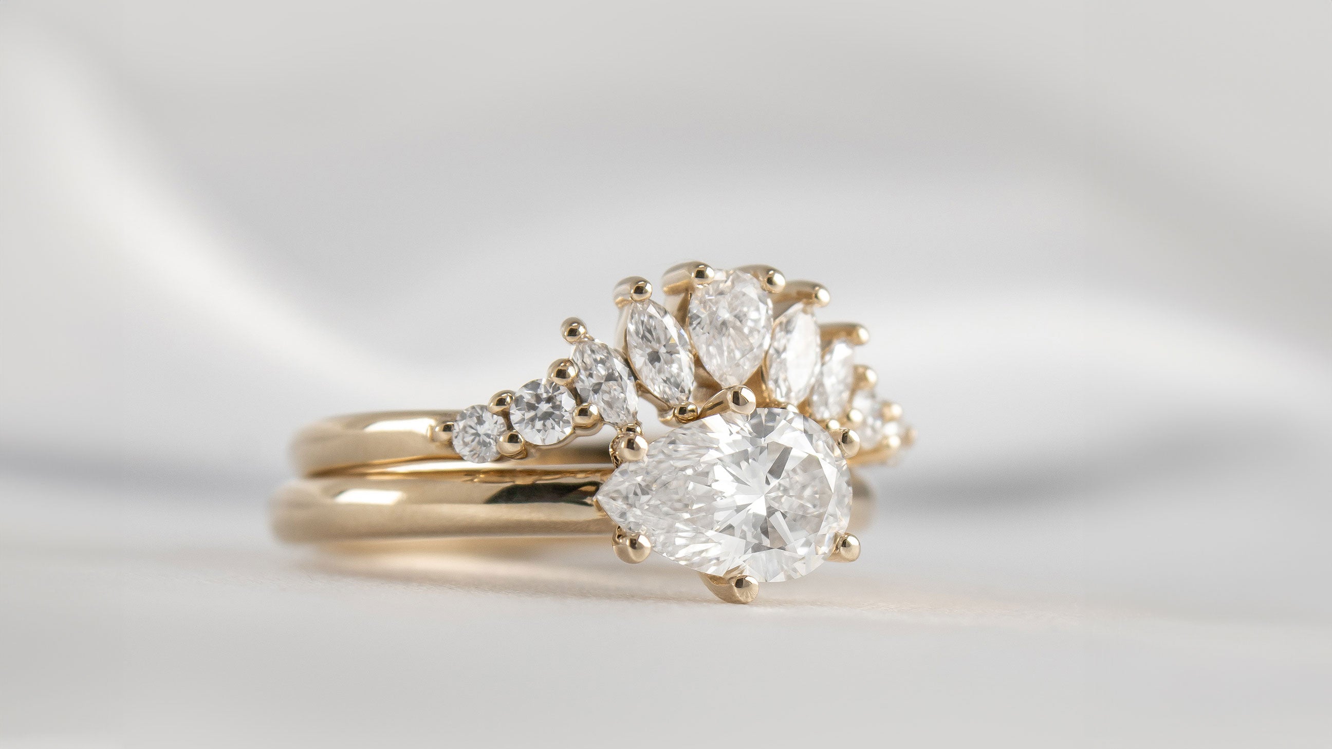 The Gabby curved wedding ring with Mia east west pear diamond engagement ring | Lisa Robin