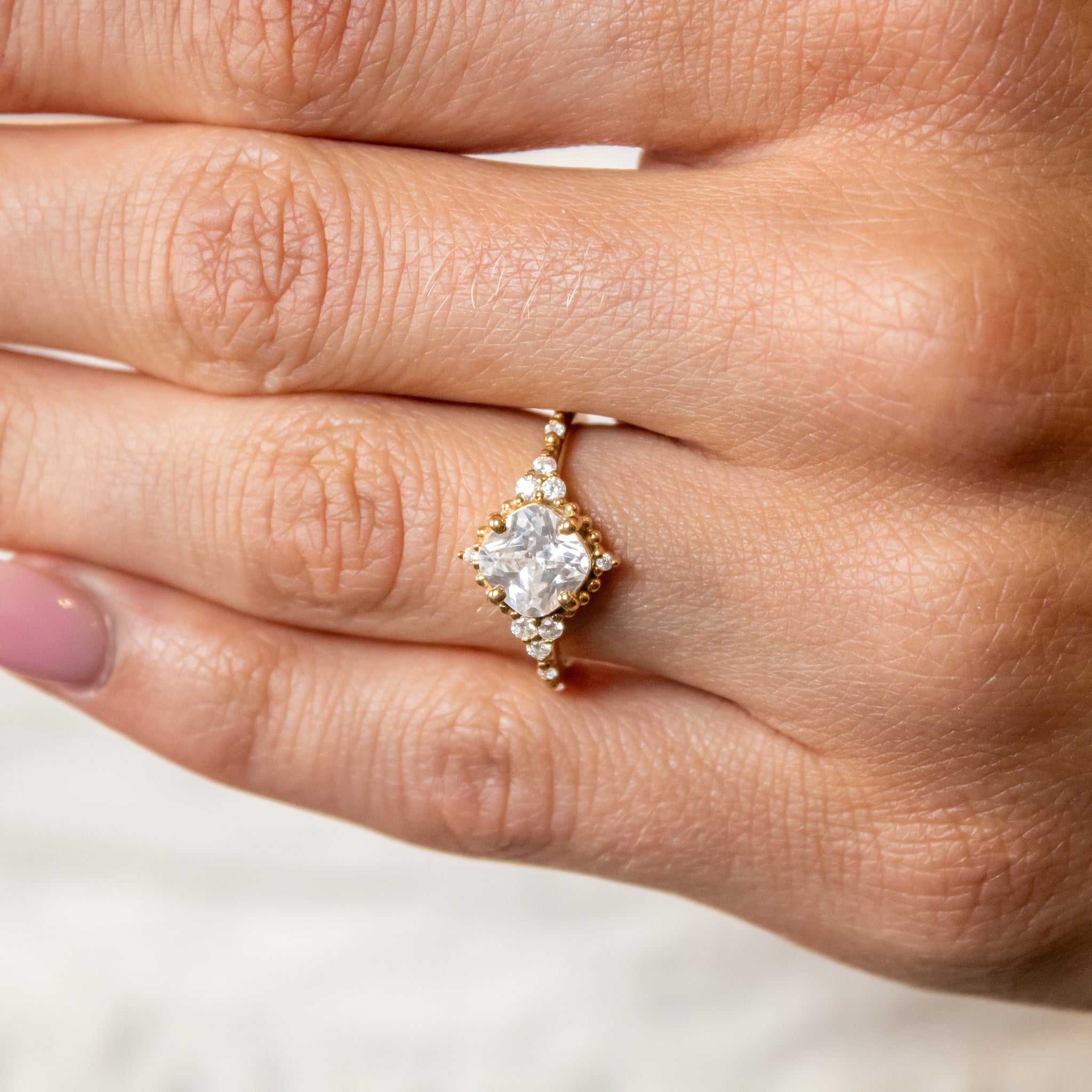 Shown in 2 Carat Diamond*The Galaeth Cluster Diamond Engagement Ring with cushion cut diamond in yellow gold on model hand by Lisa Robin#color_14k-yellow-gold