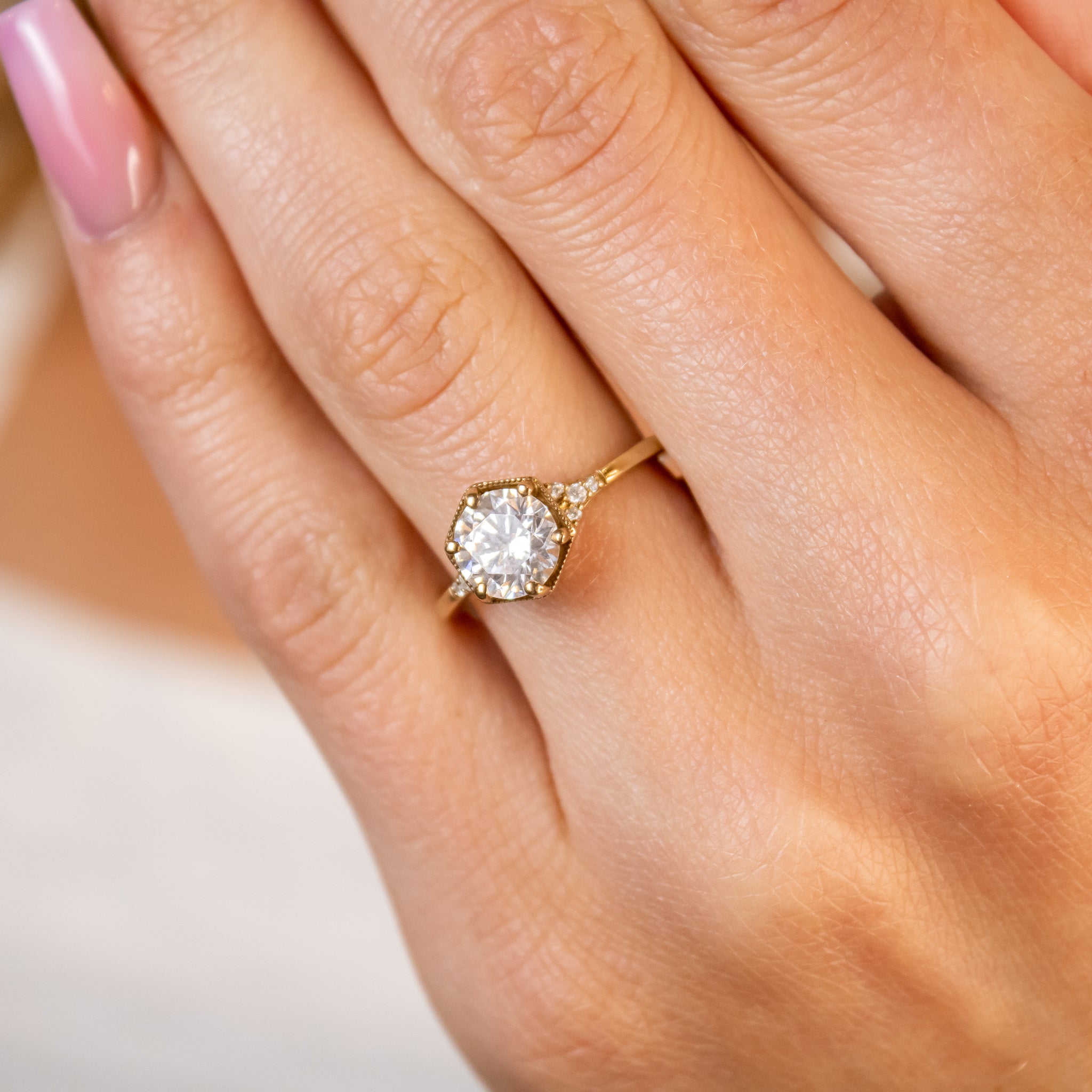 Shown in 1.0 carat Diamond* The Genevieve Hexagon Round Diamond Engagement Ring on model hand | Lisa Robin#color_14k-yellow-gold