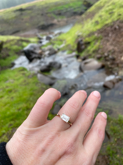 East west emerald diamond engagement ring on hand | Lisa Robin