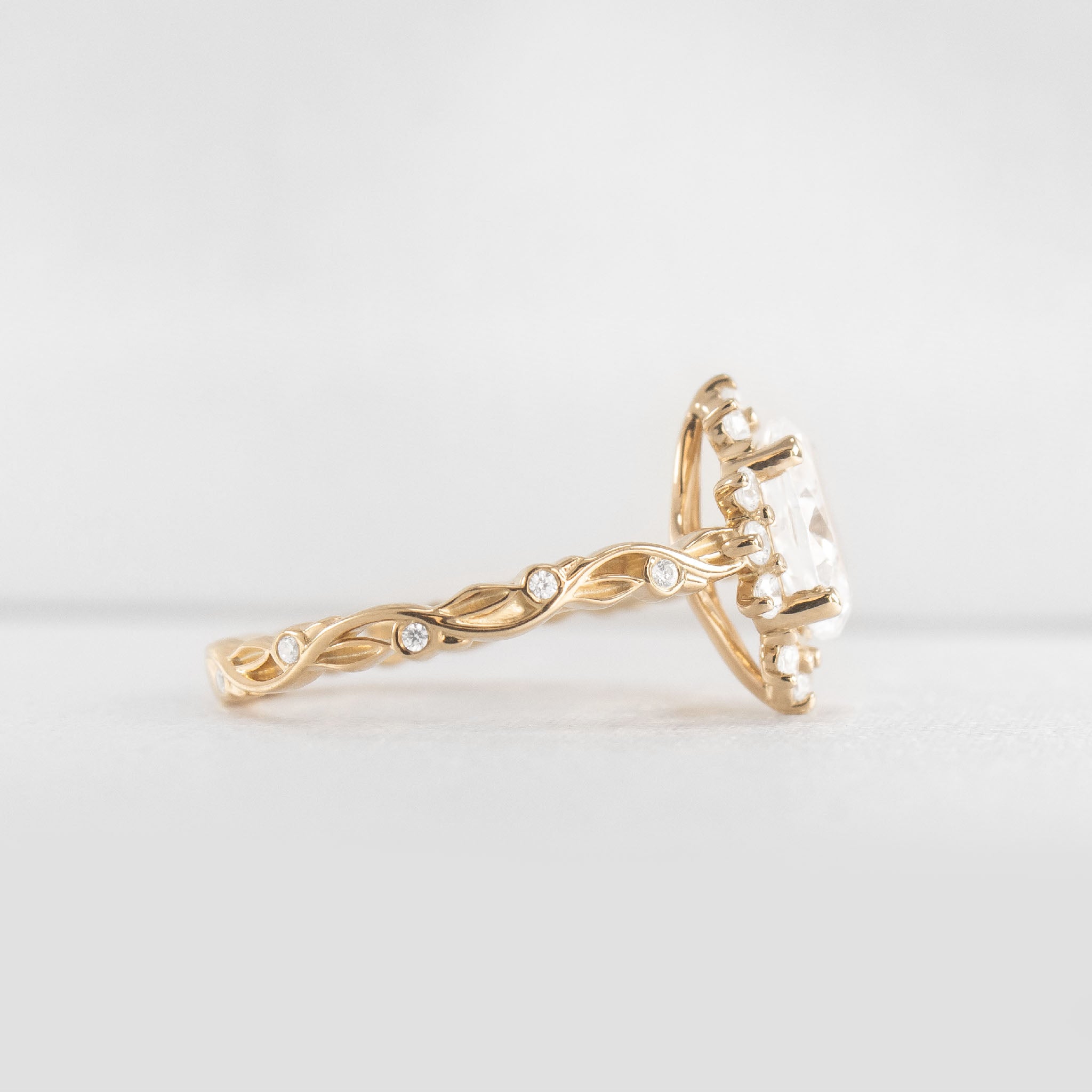 Shown in 1 Carat Diamond*The Ivy Leaf and Vine Halo Diamond Engagement Ring with oval cut diamond in yellow gold from side view by Lisa Robin#color_14k-yellow-gold