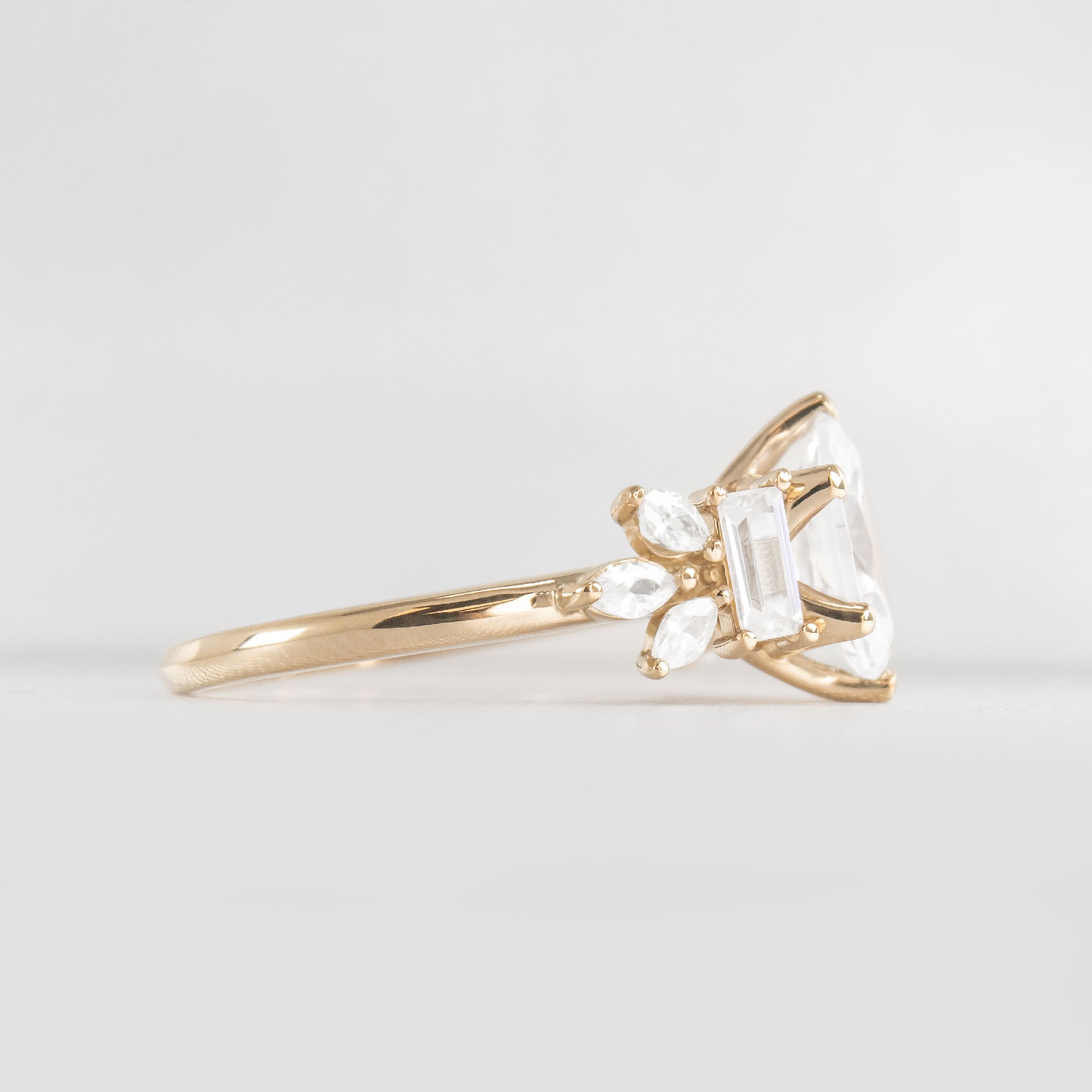 Shown in 3 Carat Diamond*The Juniper Baguette and Marquise Diamond Engagement Ring with oval cut diamond in yellow gold from side view by Lisa Robin#color_14k-yellow-gold