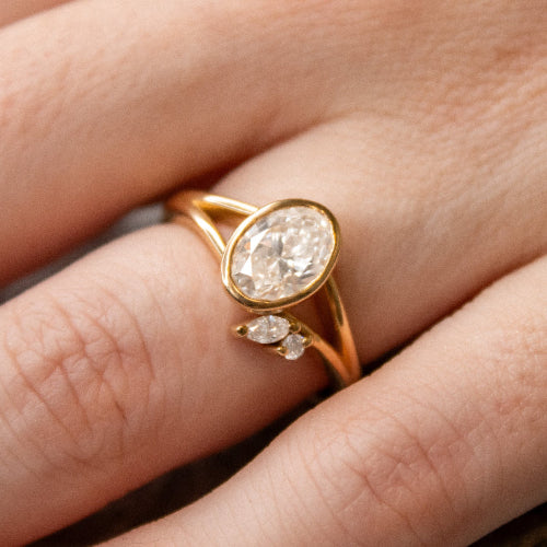 Shown in 1.5 Carat Diamond*The Kallely bezel Diamond Engagement Ring with oval cut diamond in yellow gold on model hand by Lisa Robin#color_14k-yellow-gold