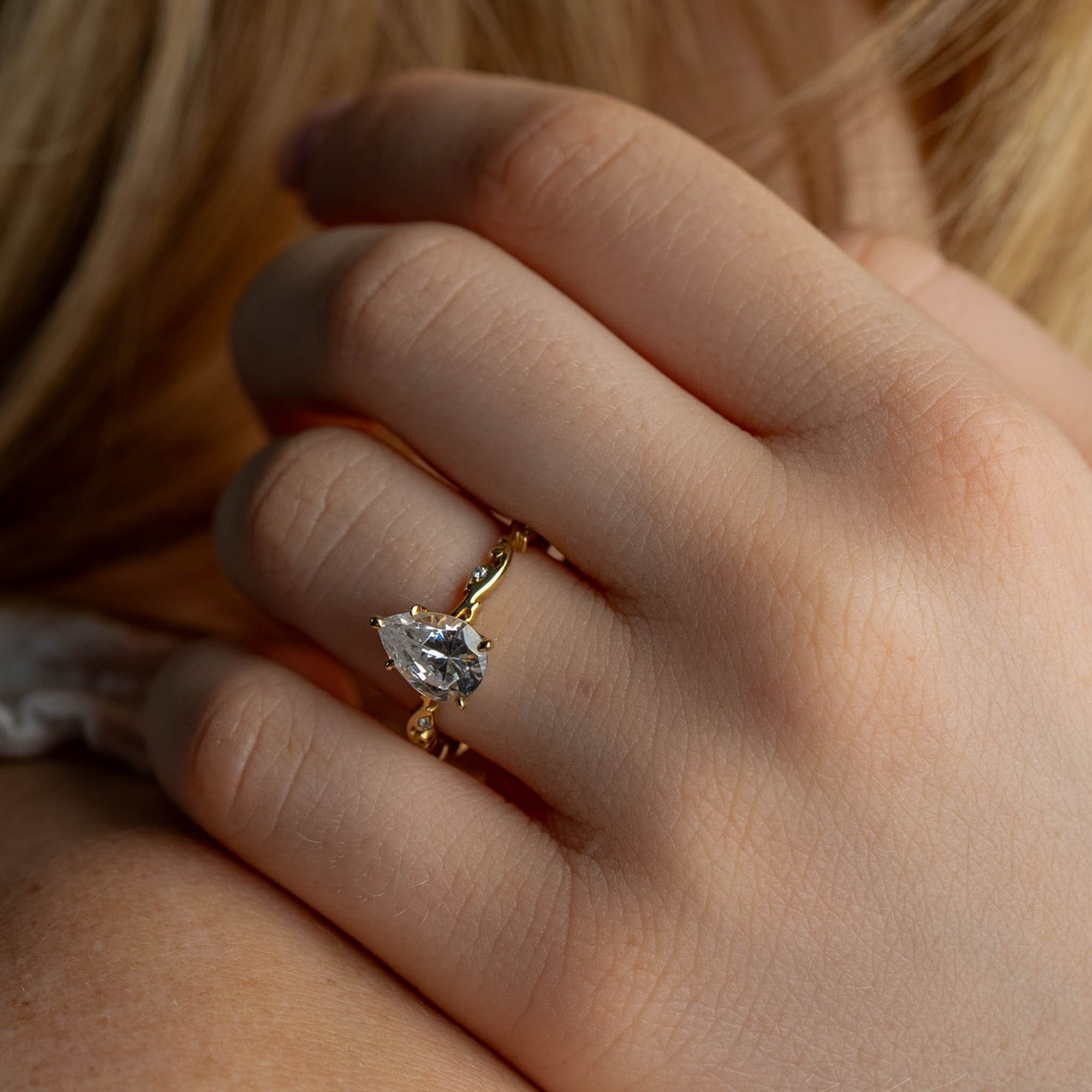 Shown in 2 Carat Diamond*The Laurel Leaf and Vine Engagement Ring with pear cut diamond in yellow gold on a model hand by Lisa Robin#color_14k-yellow-gold