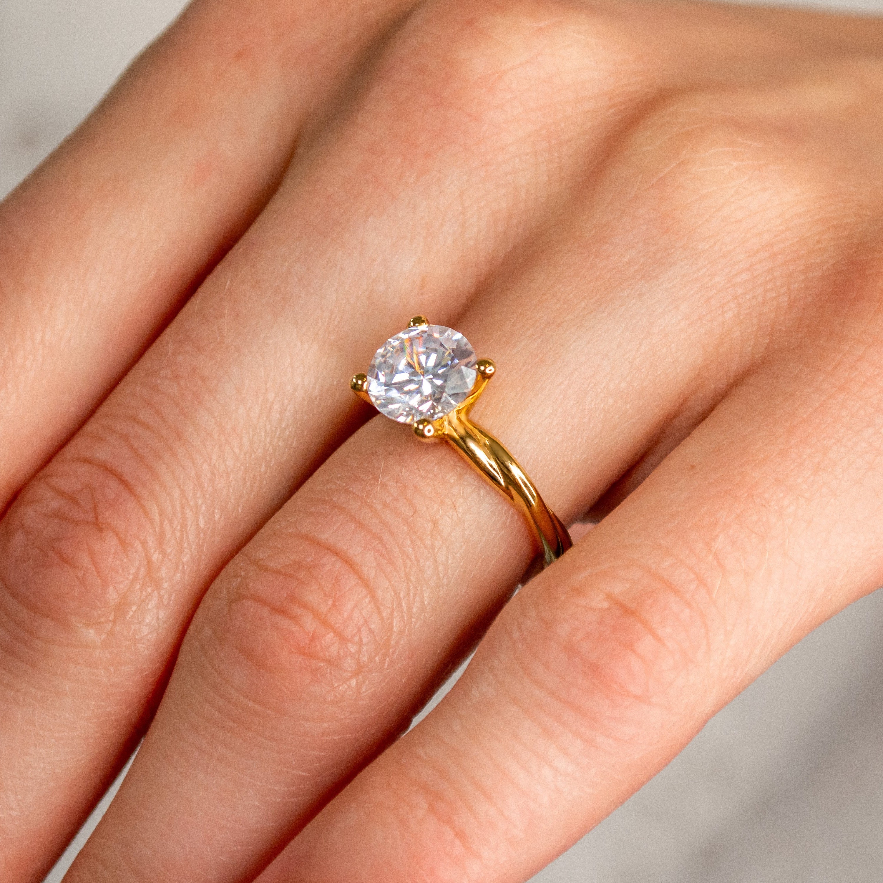 Shown in 1.5 Carat Diamond*The Leila Twist Engagement Ring with round cut diamond in yellow gold on model hand by Lisa Robin#color_14k-yellow-gold