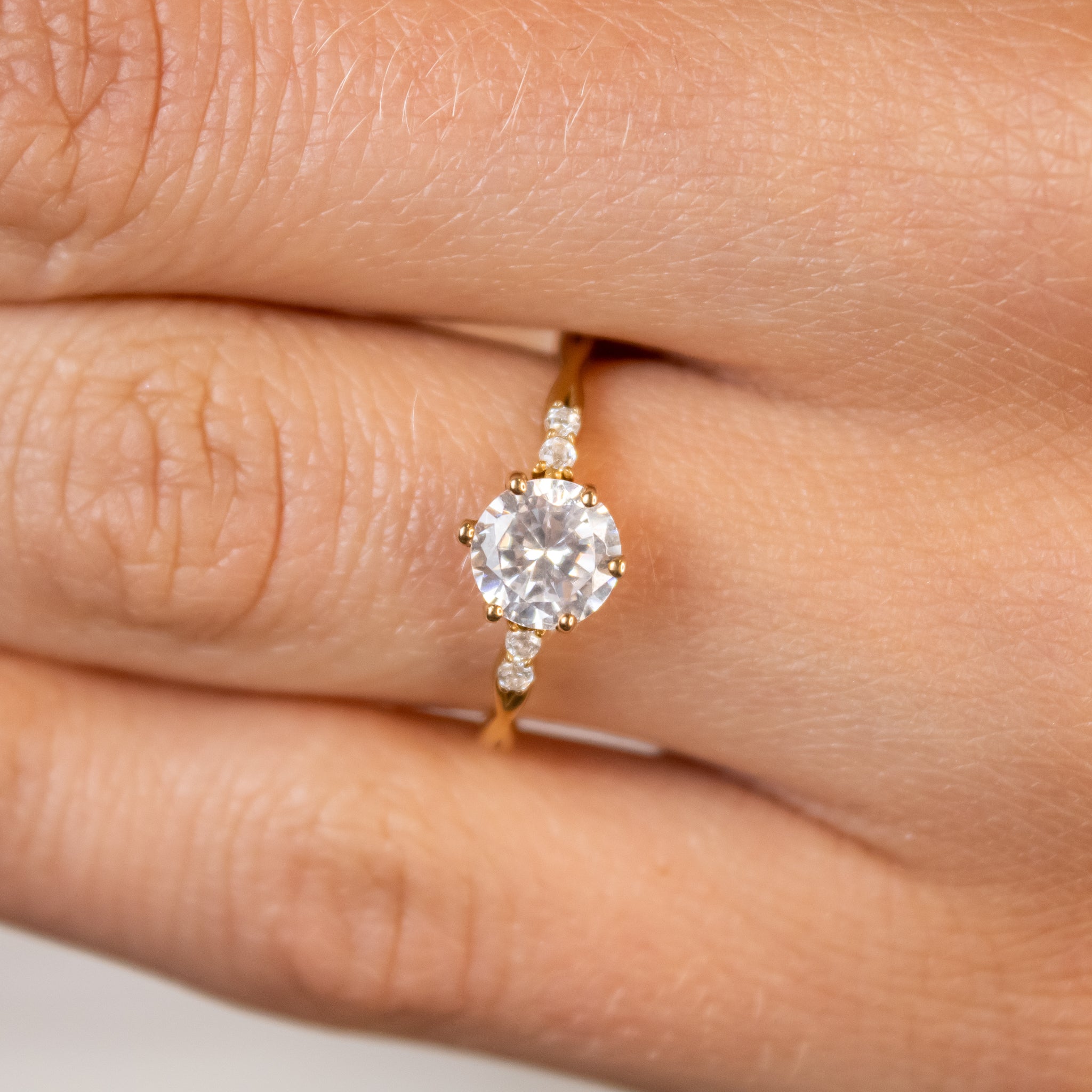 Shown in 1.5 Carat Diamond*The Liana delicate twist Diamond Engagement Ring with round cut diamond in yellow gold on model hand by Lisa Robin#color_14k-yellow-gold