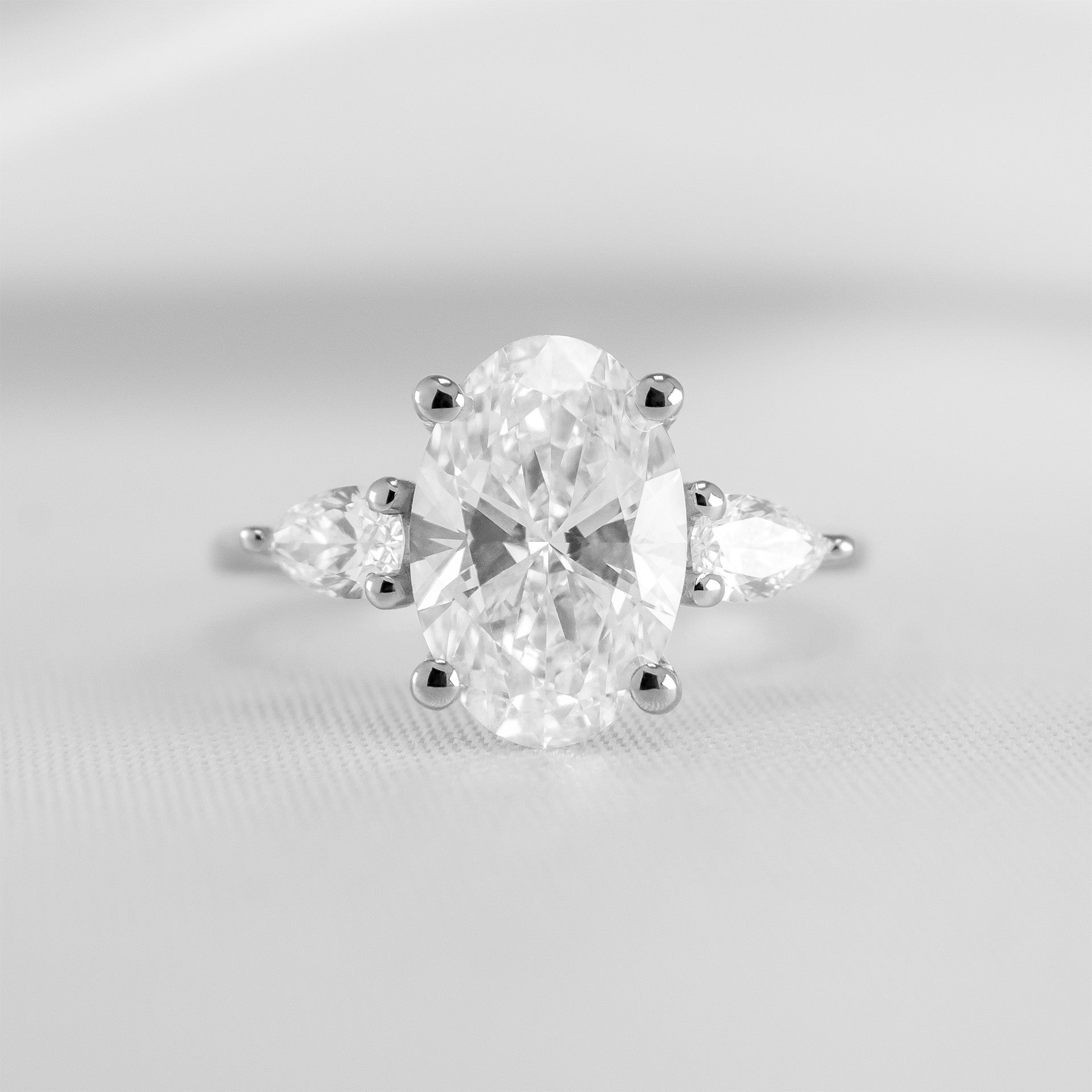 Shown in 2.6 Carat Diamond*The Melayna Three Stone Engagement Ring with oval cut diamond in white gold from the front by Lisa Robin#color_14k-white-gold