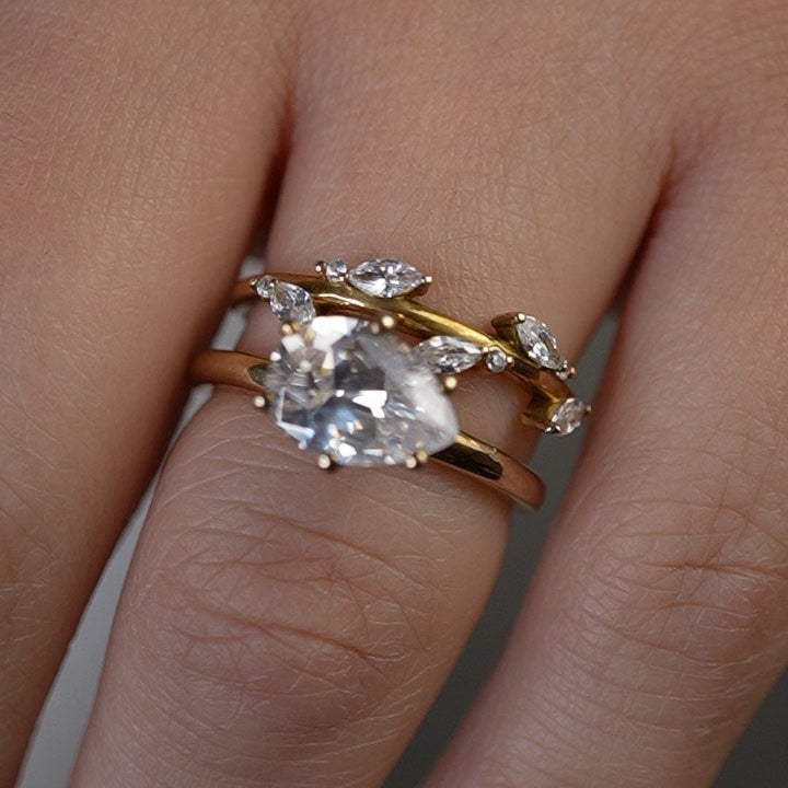 Shown in 1.75 Carat*The Mia East West emerald cut Diamond Solitaire Engagement Ring in yellow gold on model hand by Lisa Robin#color_14k-yellow-gold#shape_pear
