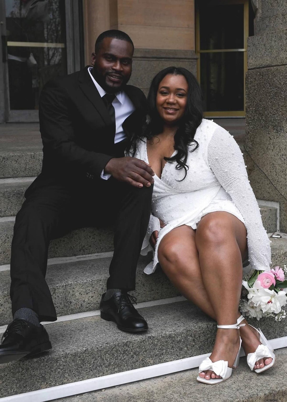 Wedding couple sitting on courthouse steps just after wedding | Lisa Robin