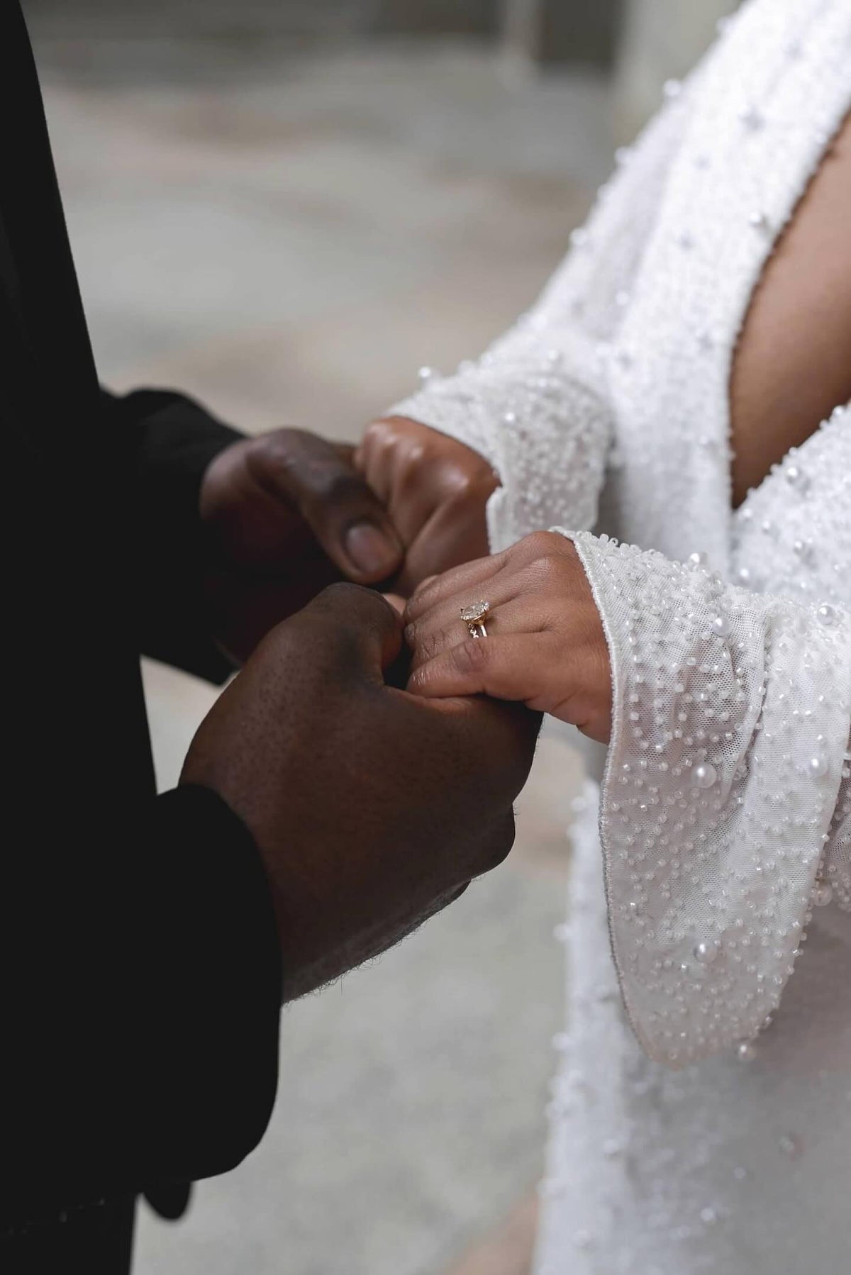 Engagement ring and wedding ring on bride holding grooms hands | Lisa Robin