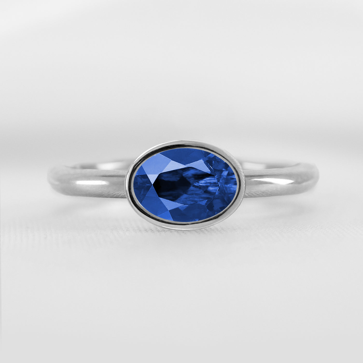 Shown in 1.30 Carat Blue Sapphire * The Nova East West Sapphire Bezel Engagement Ring#color_platinum