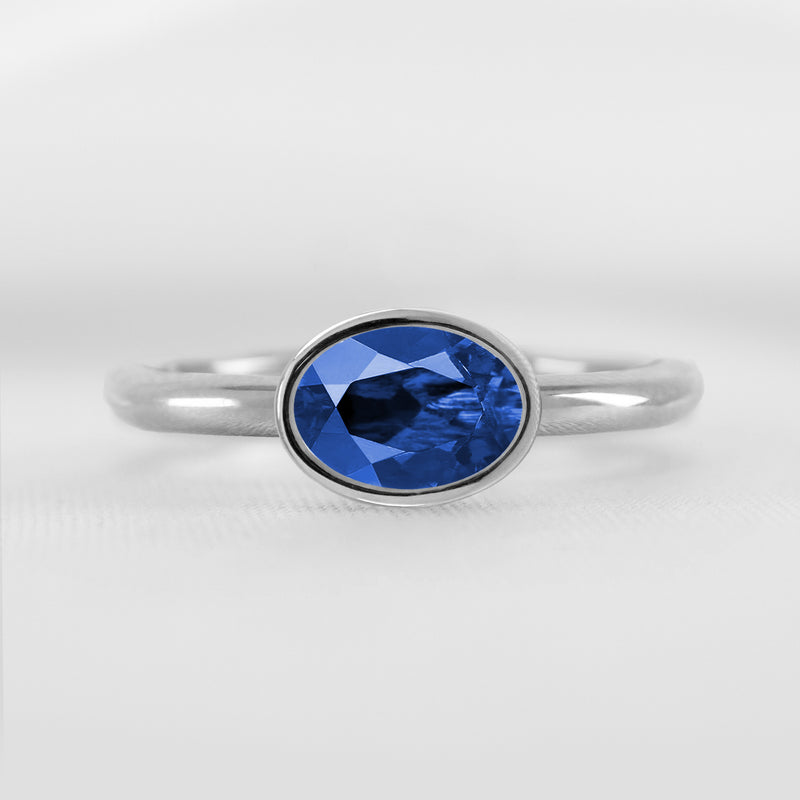 Shown in 1.30 Carat Blue Sapphire * The Nova East West Sapphire Bezel Engagement Ring