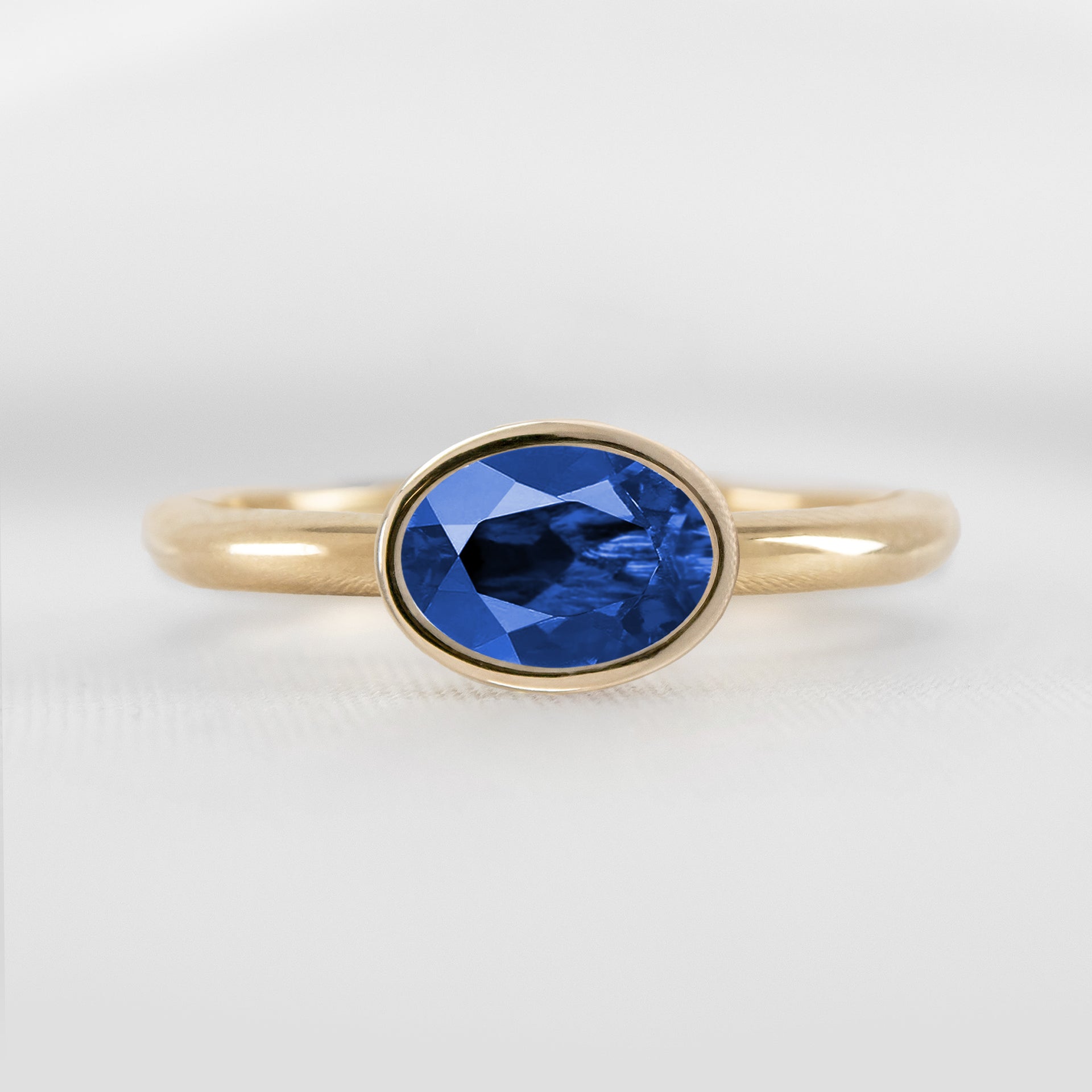 Shown in 1.30 Carat Blue Sapphire * The Nova East West Sapphire Bezel Ring#color_14k-yellow-gold