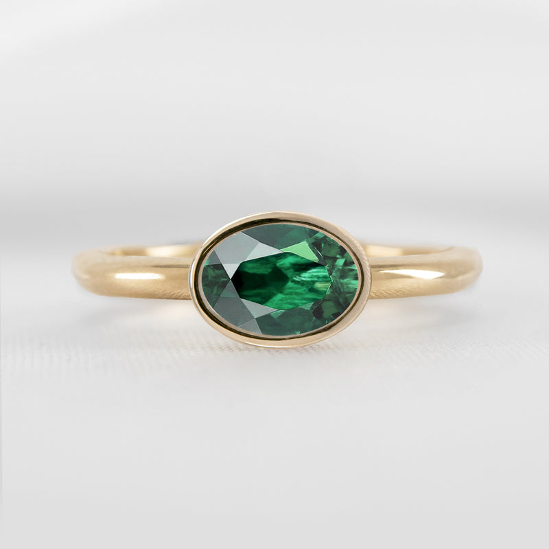 Shown in 1.30 carat Green Emerald* The Nova Green Emerald East-West Bezel Engagement Ring | Lisa Robin